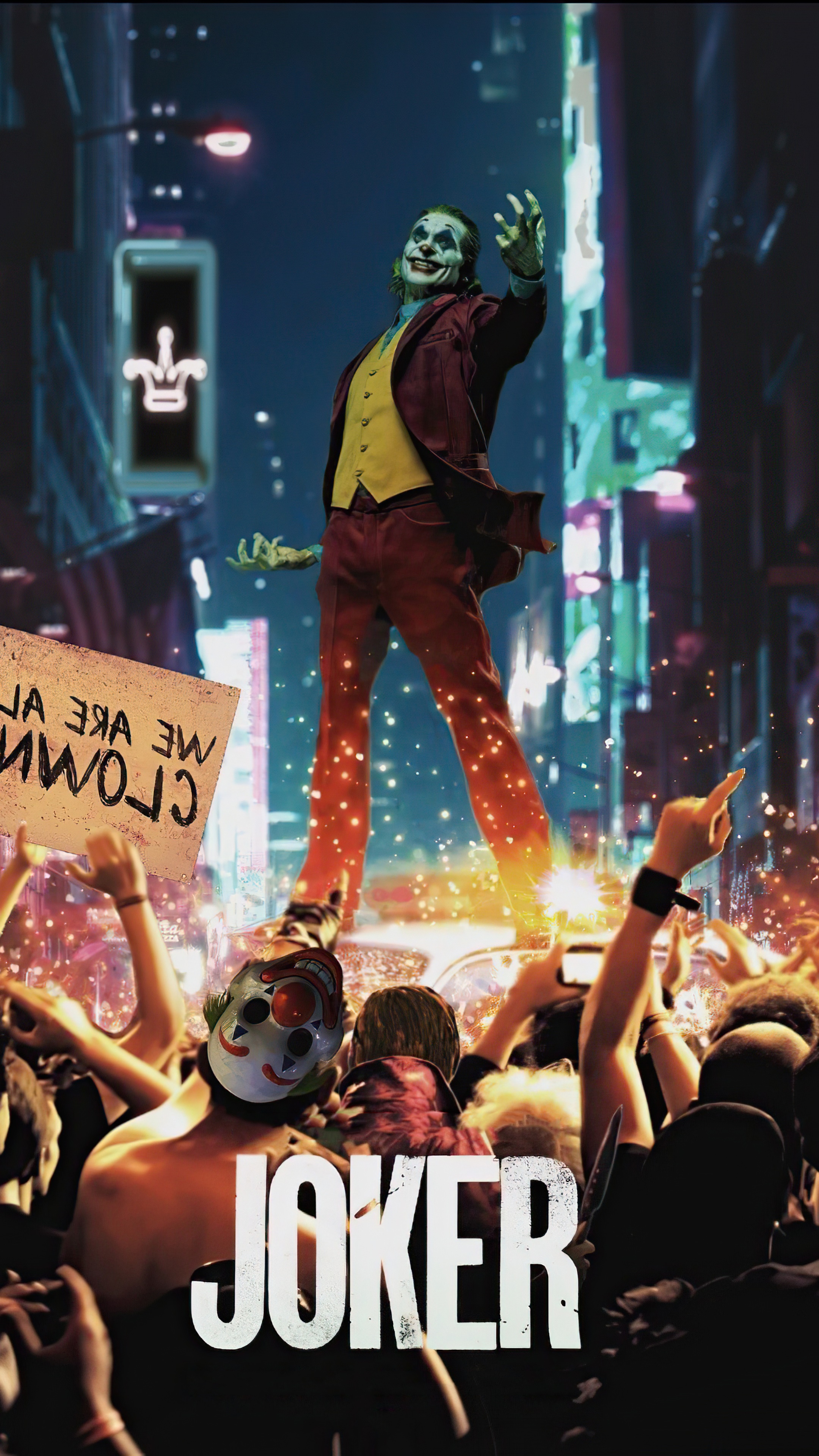 Joker standing in a crowd with a sign HD Phone Wallpaper