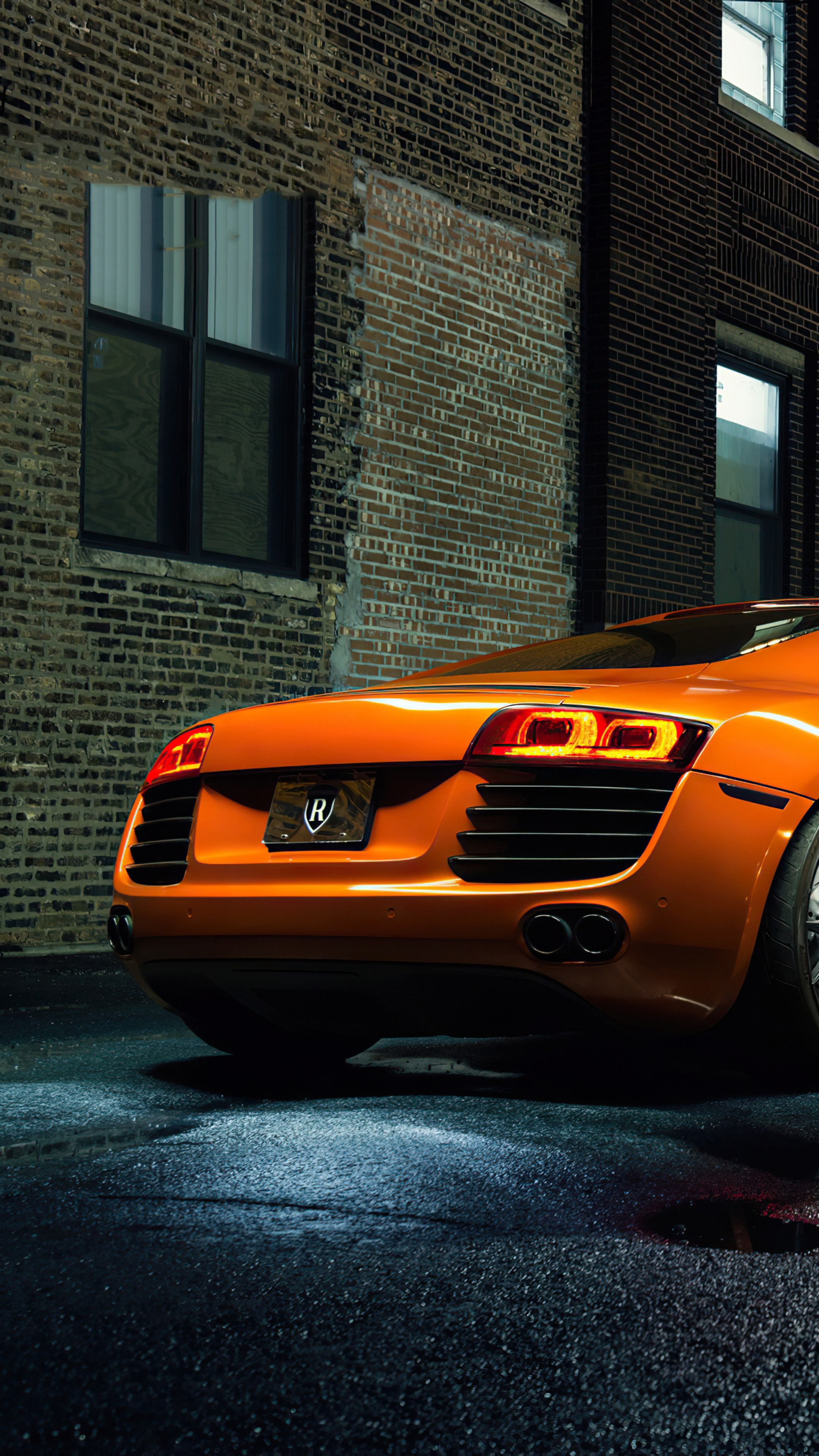 Orange Audi R8 parked by brick building HD Phone Wallpaper