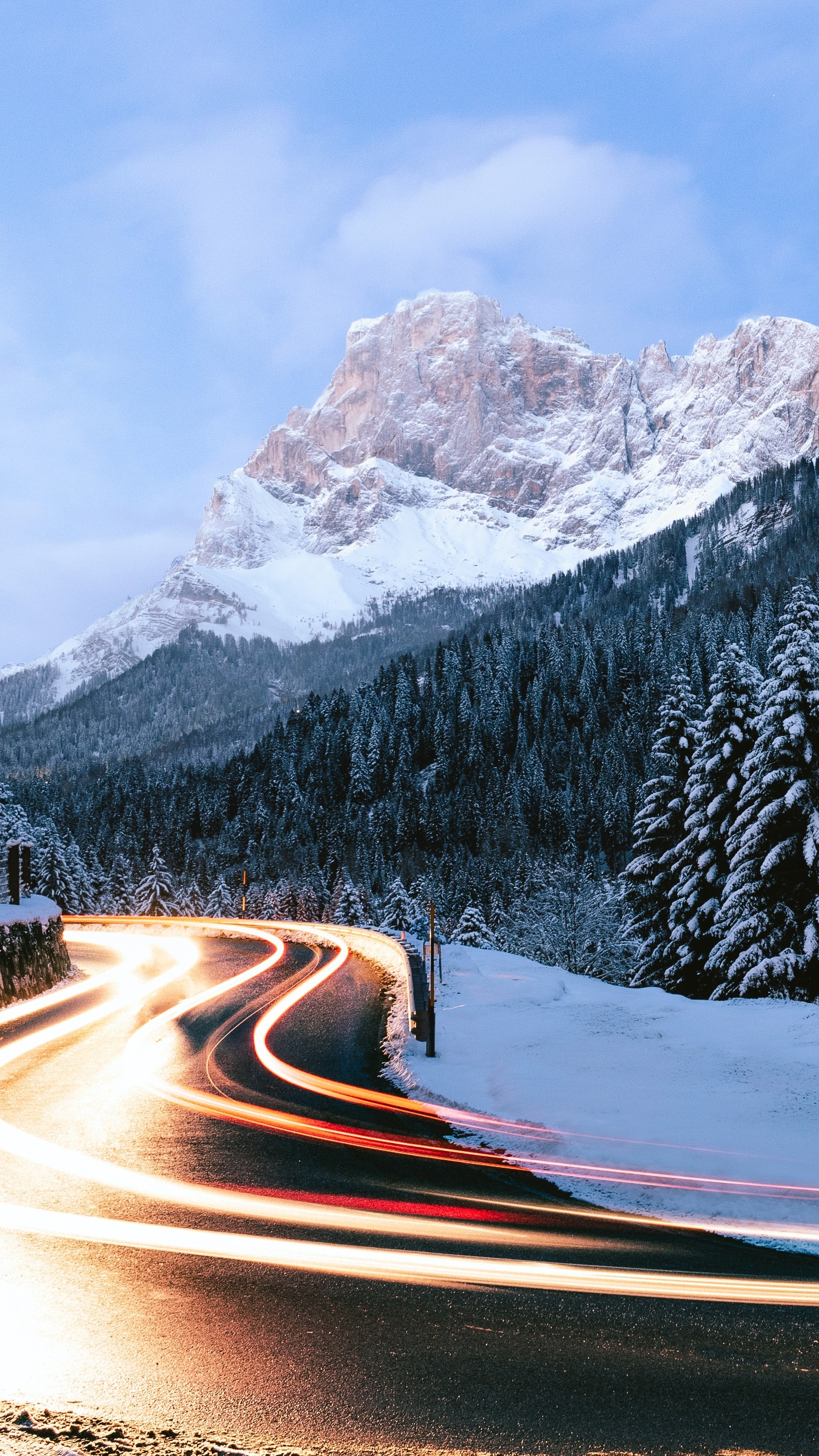 Long exposure of a snowy mountain road at dusk HD Phone Wallpaper