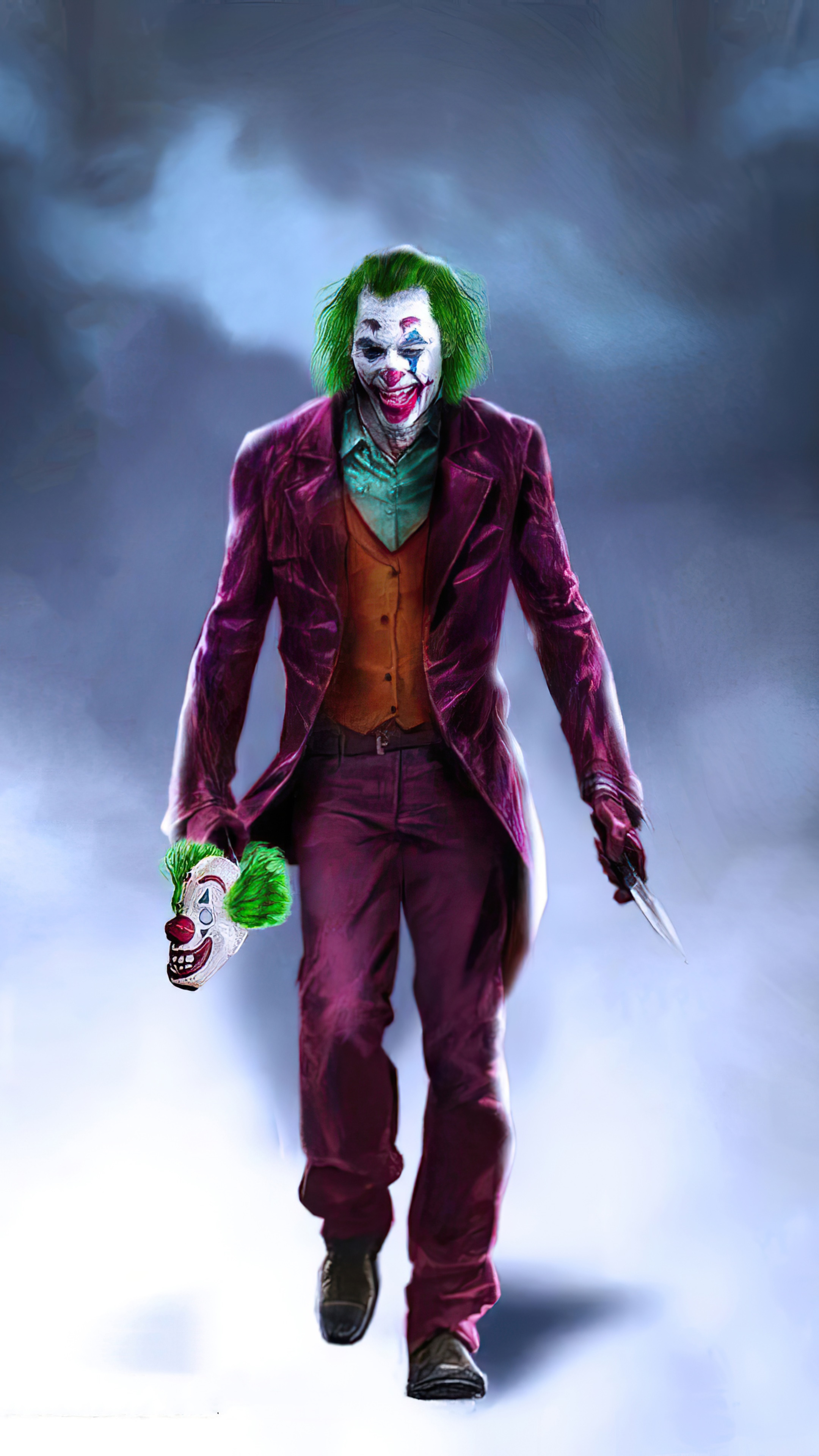 Joker holding a clown mask and knife HD Phone Wallpaper