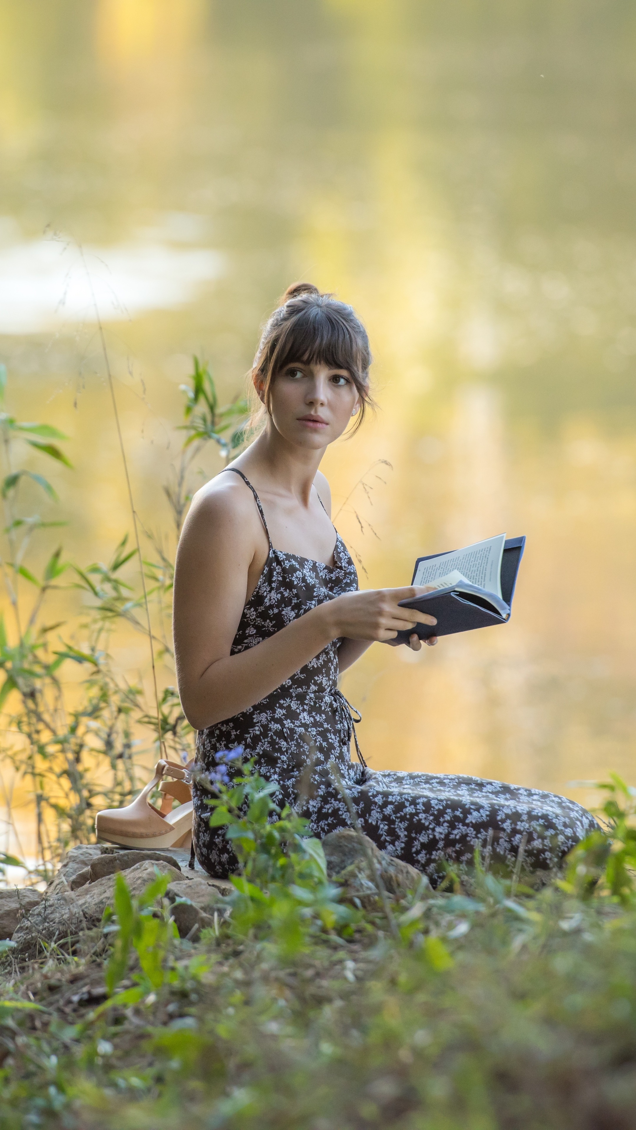 Ella Hunt reading a book by a lake HD Phone Wallpaper