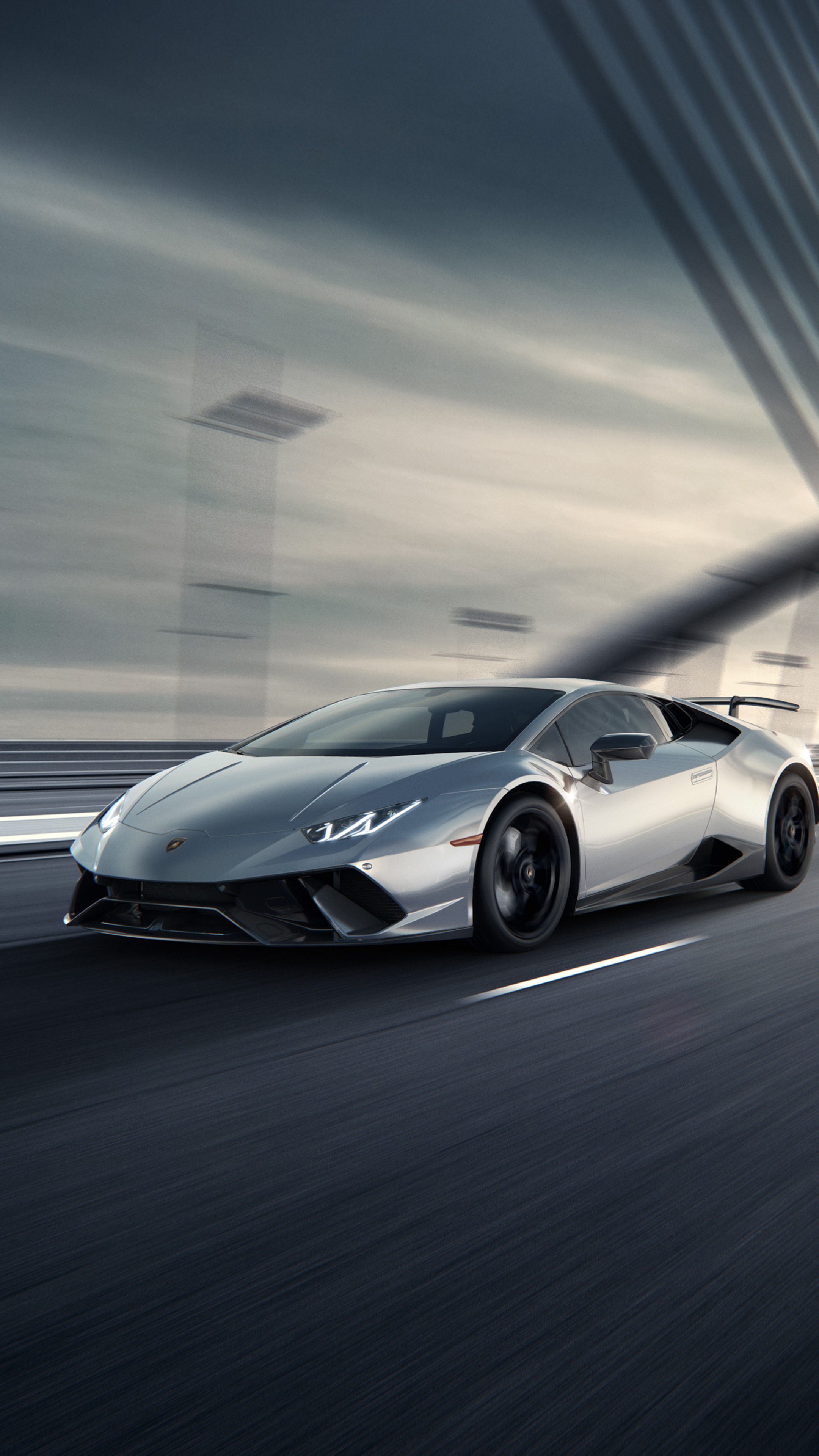 Silver Lamborghini Huracan driving on a road HD Phone Wallpaper