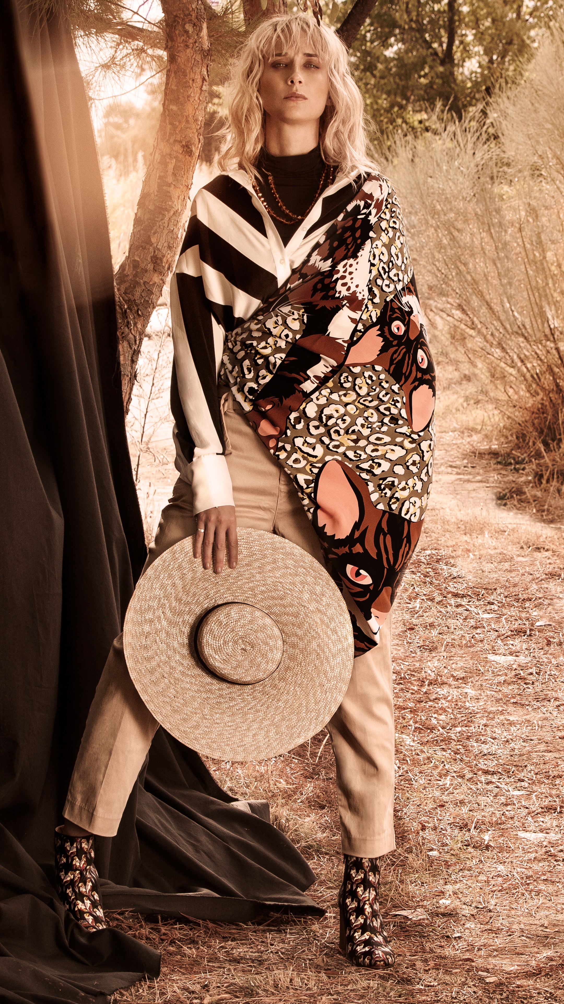 Ingrid Garcia Jonsson in patterned clothing holding a hat HD Phone Wallpaper