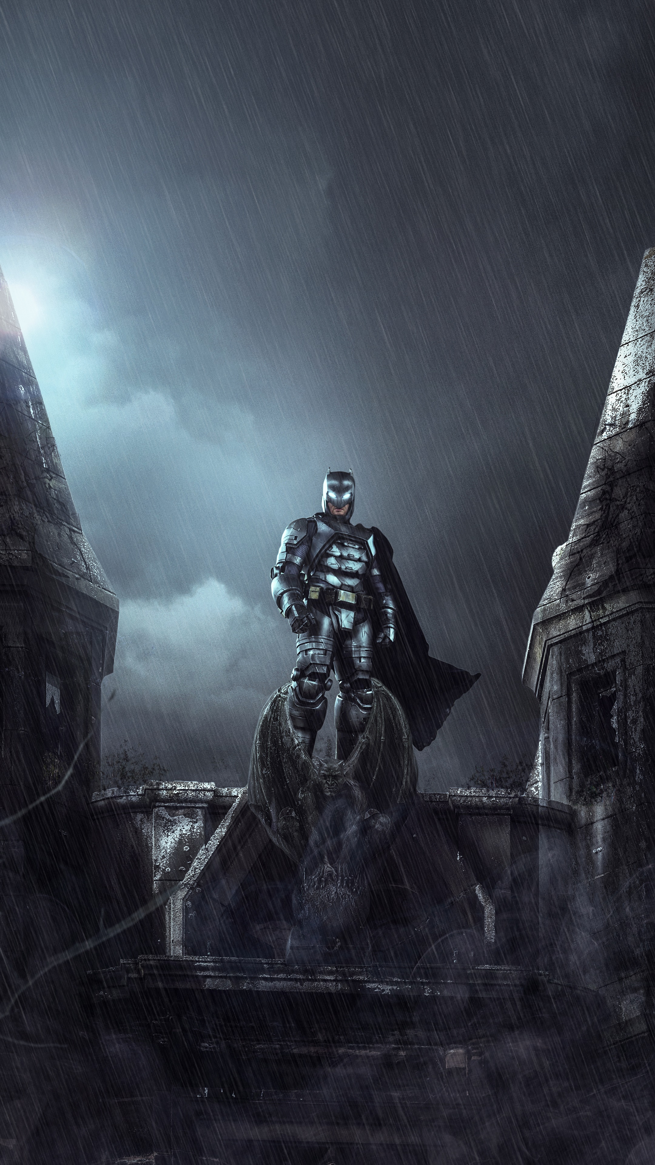 Batman standing on a gargoyle in the rain HD Phone Wallpaper