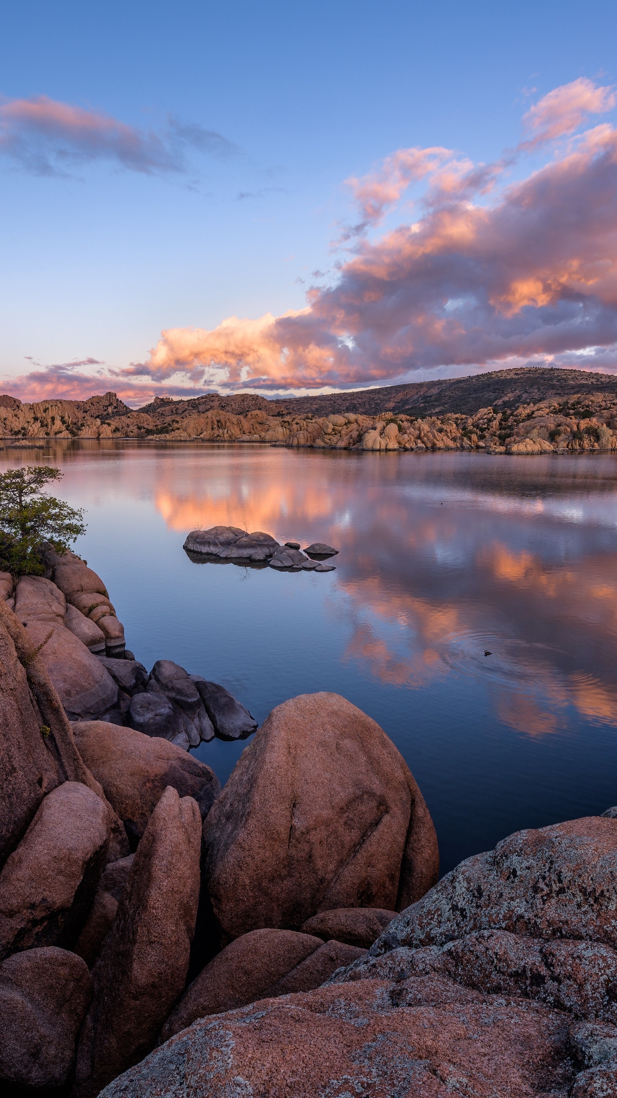 Lake with rocks and colorful clouds at sunset HD Phone Wallpaper