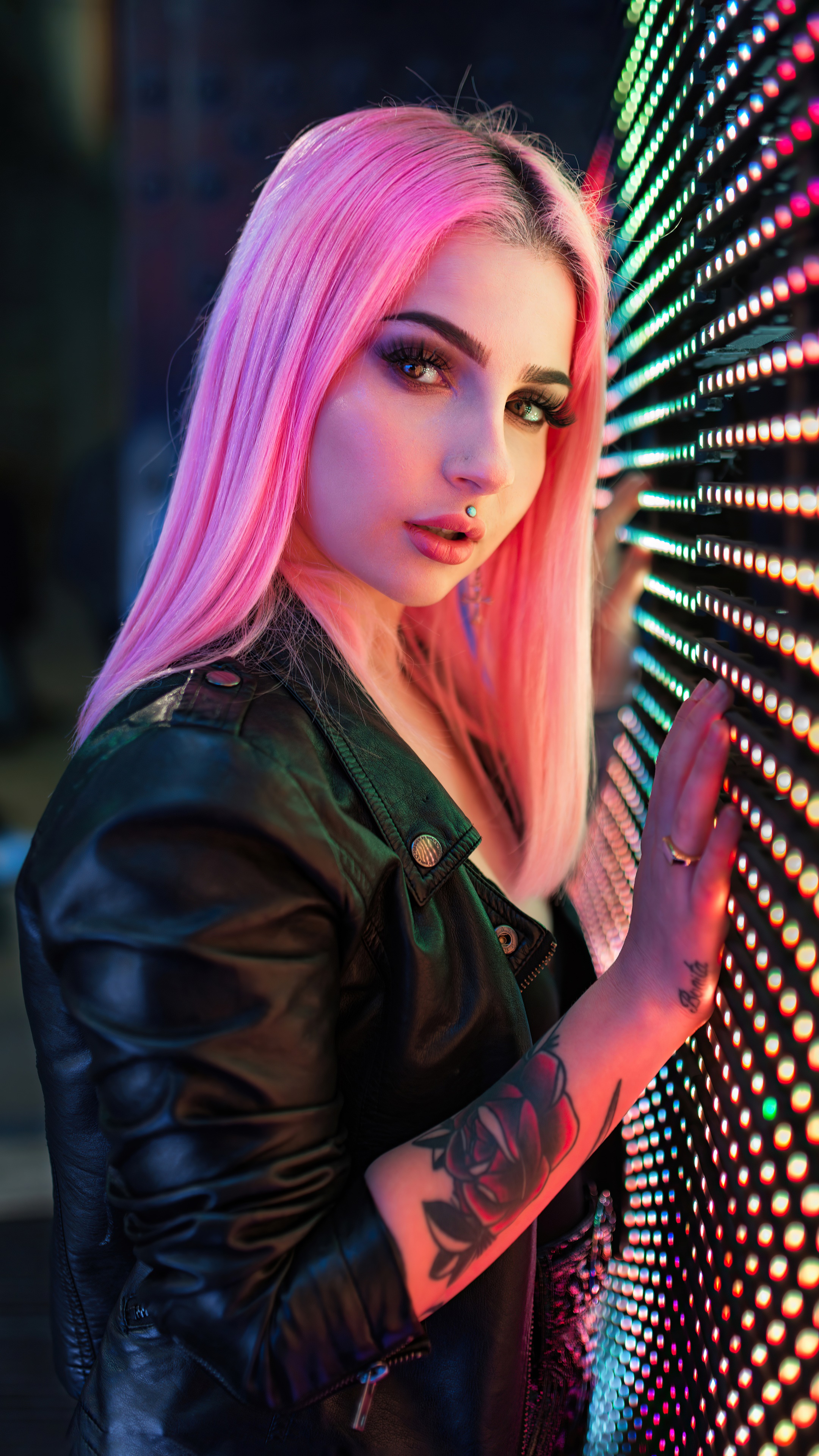 Woman with pink hair and tattoos near LED wall HD Phone Wallpaper