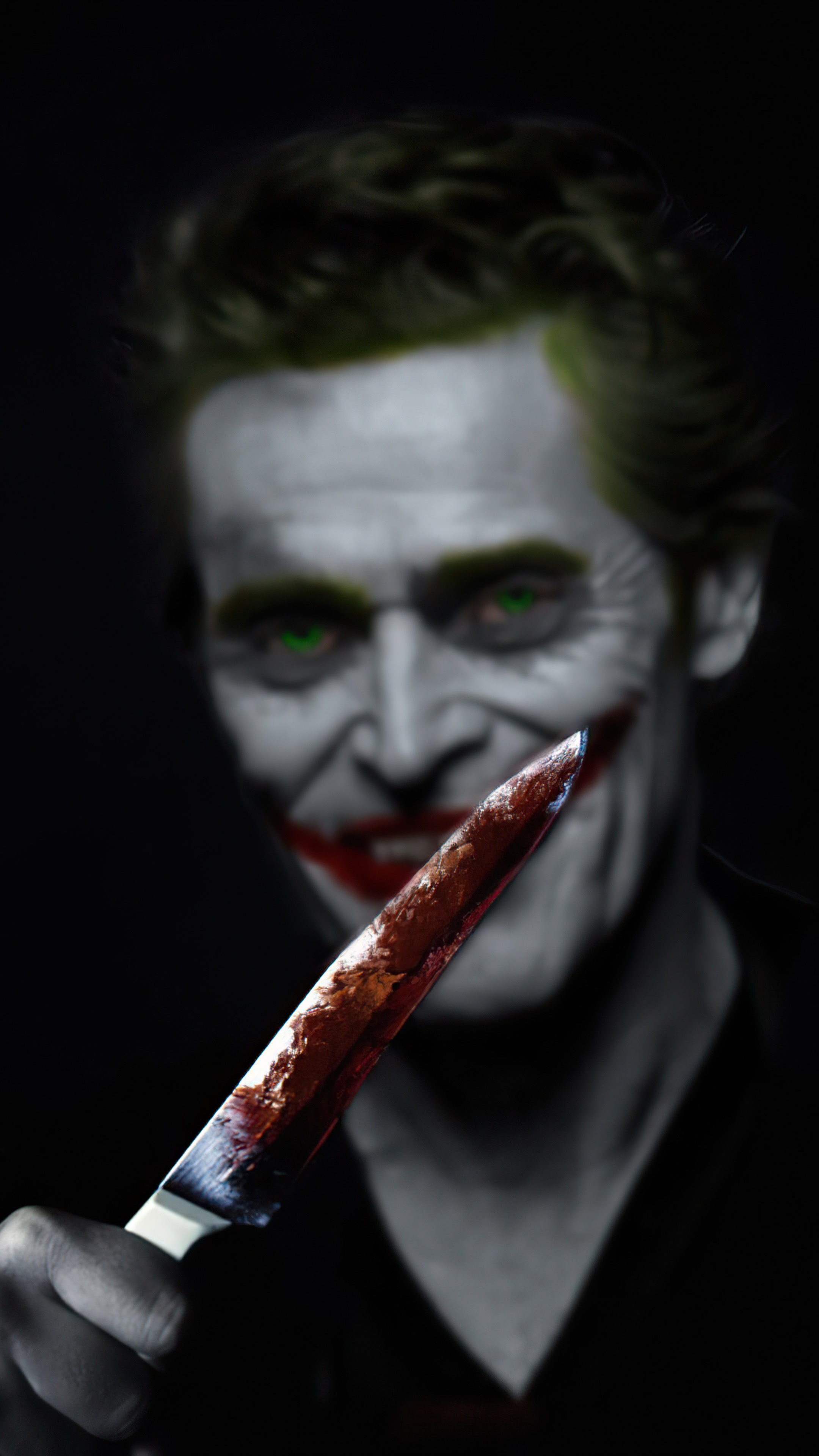 The Joker holding a bloody knife HD Phone Wallpaper