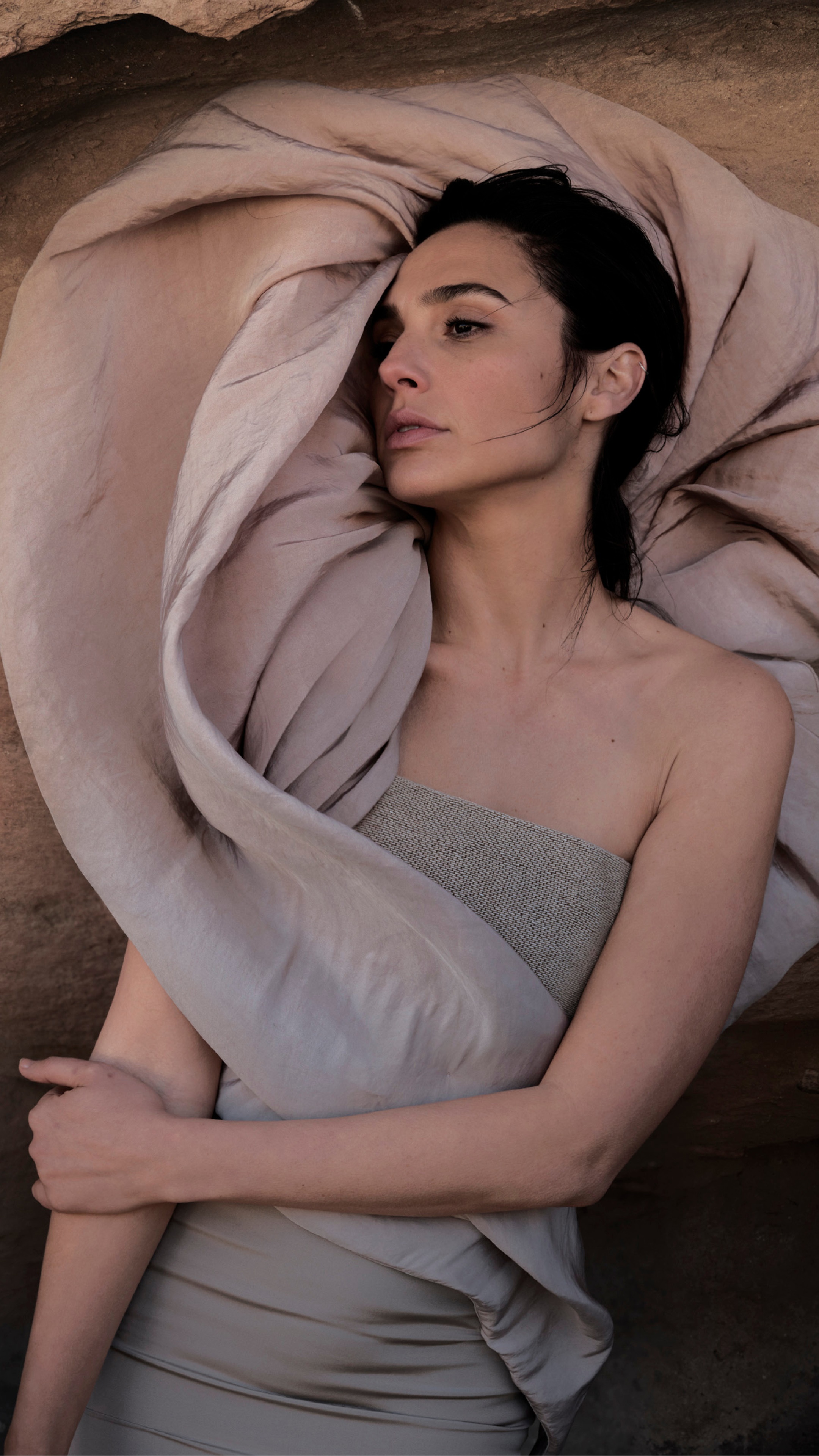 Gal Gadot lying down wrapped in fabric HD Phone Wallpaper