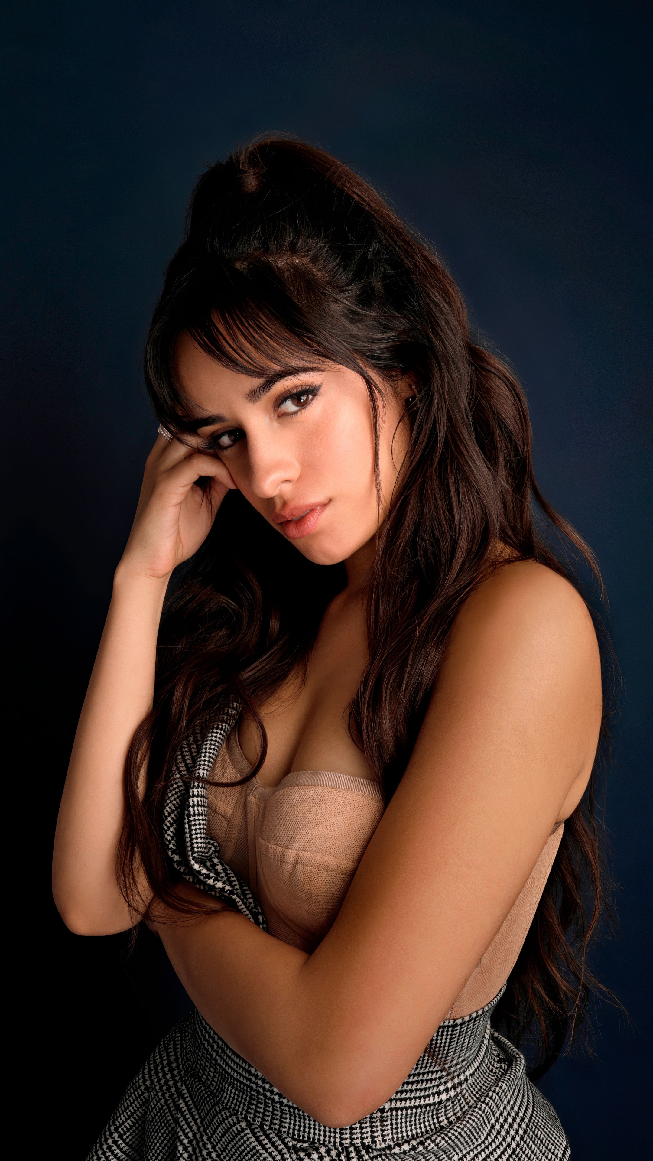 Camila Cabello posing against a dark blue background HD Phone Wallpaper