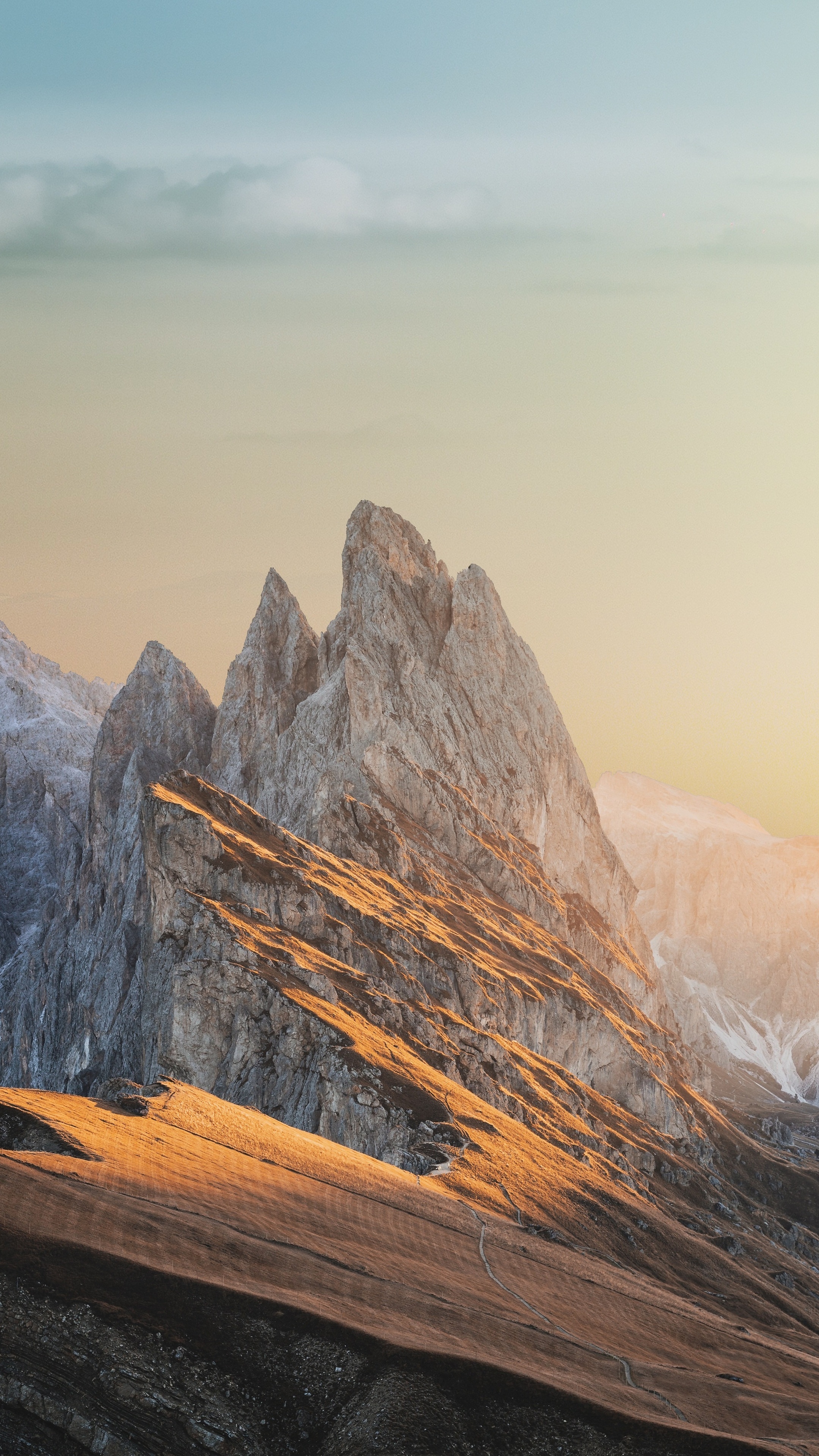Jagged mountain peaks at sunset with golden light HD Phone Wallpaper