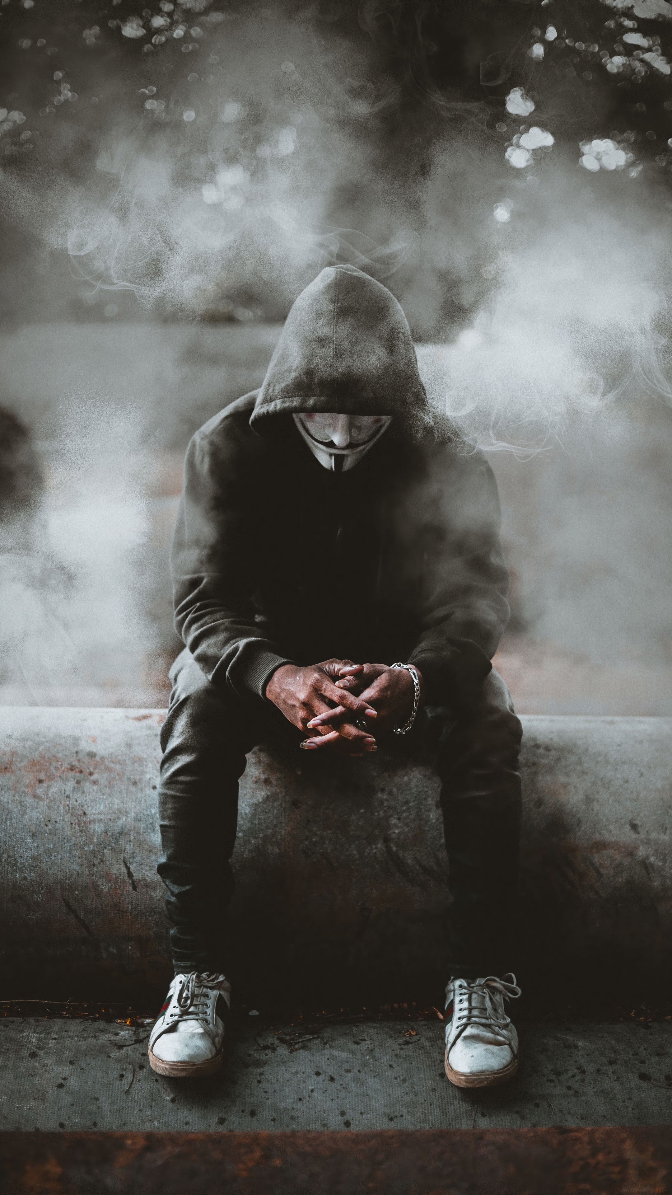 Man in Anonymous mask sitting in smoke HD Phone Wallpaper