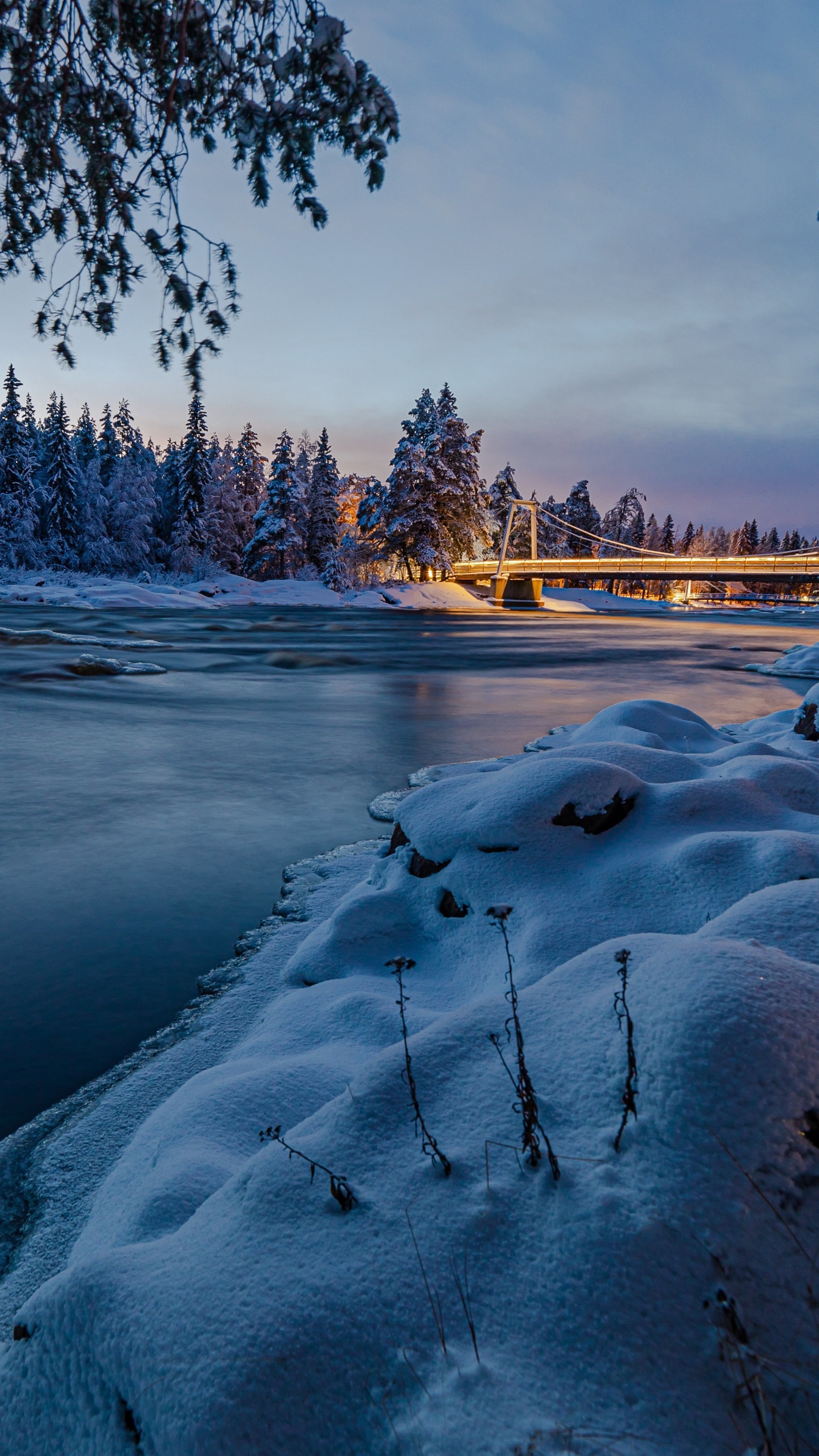 Winter scene with snow-covered trees and a bridge over a river HD Phone Wallpaper