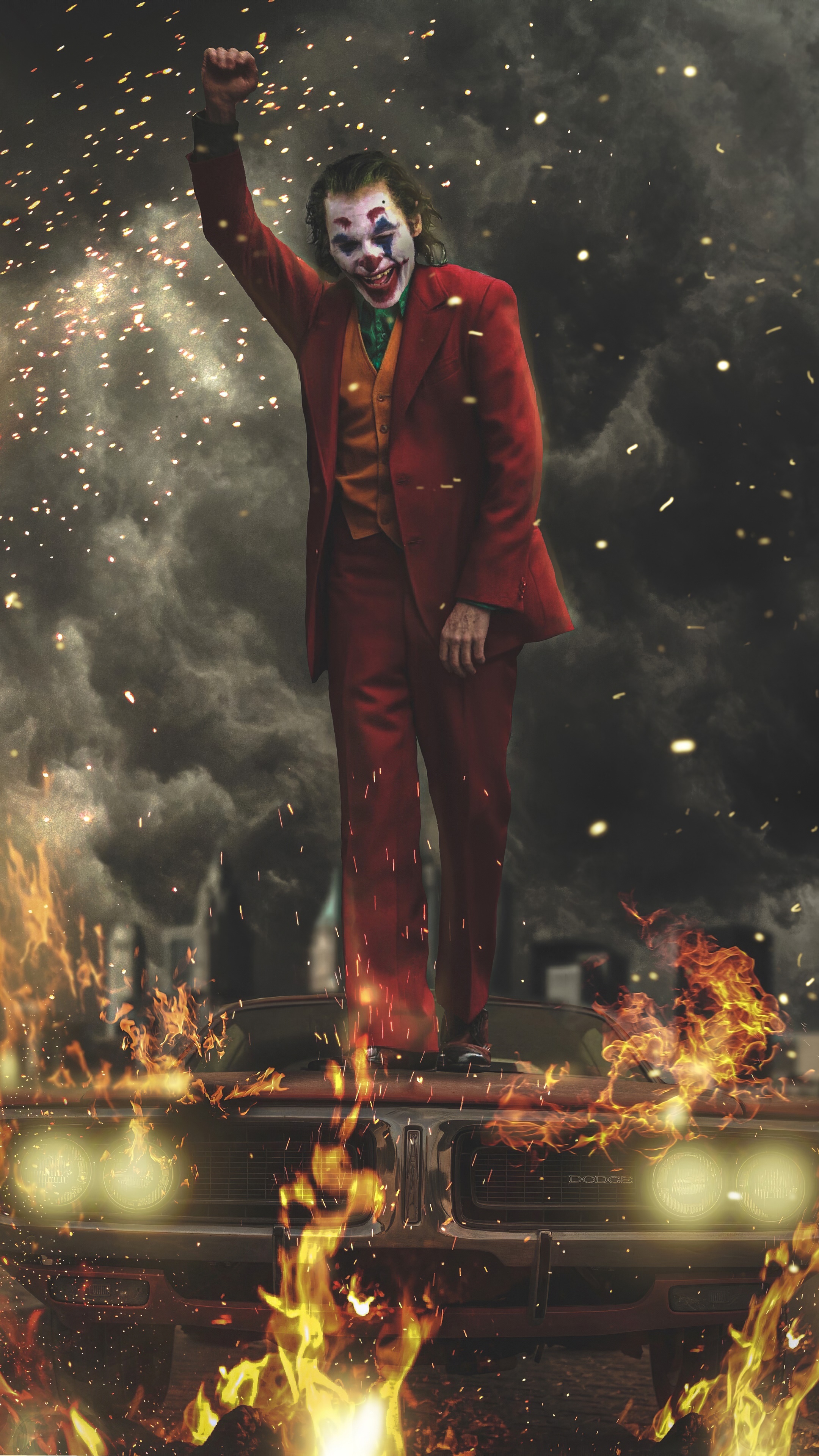 Joker standing on a burning car with fireworks HD Phone Wallpaper