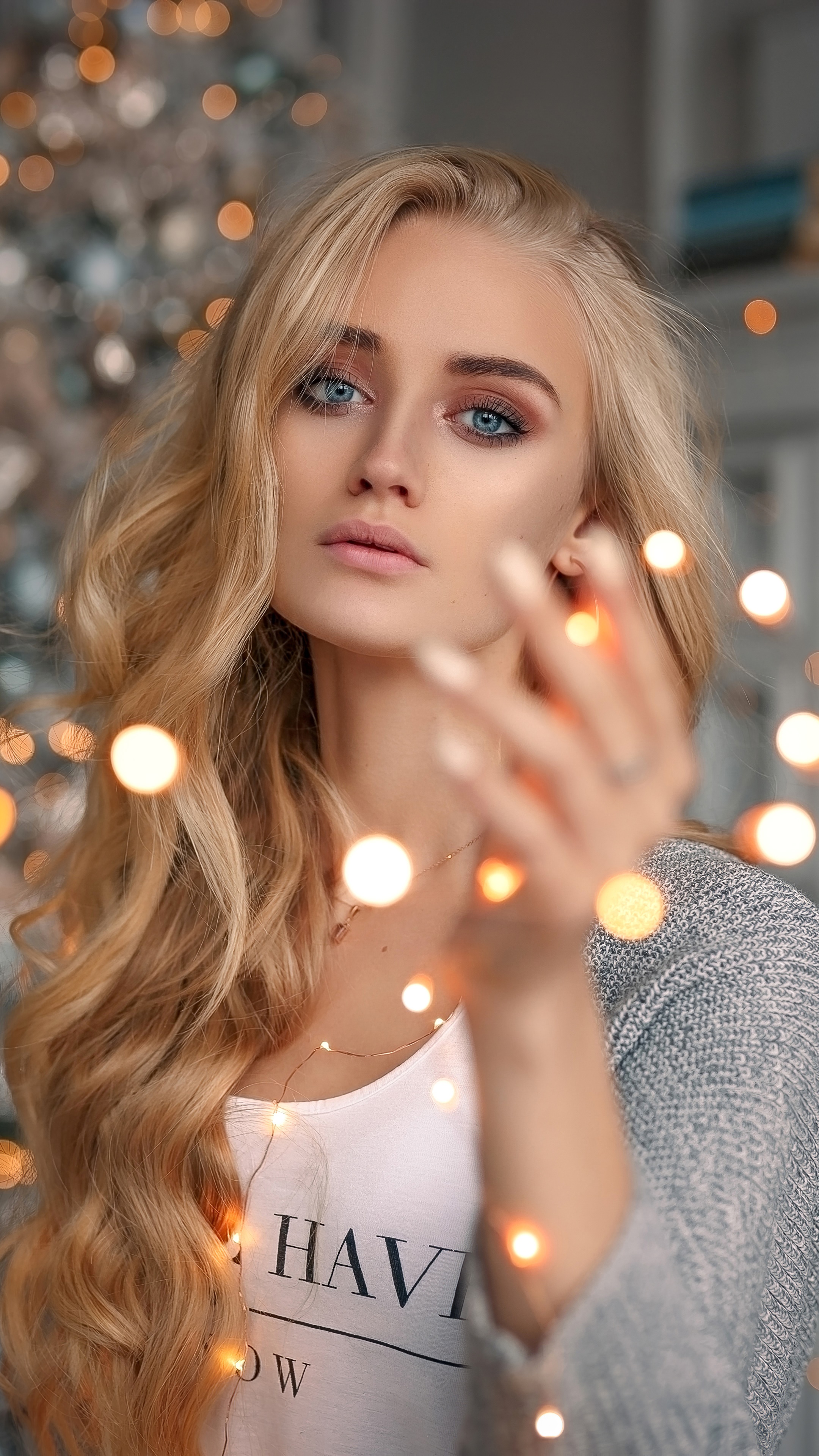 Blonde woman with blue eyes and bokeh lights HD Phone Wallpaper