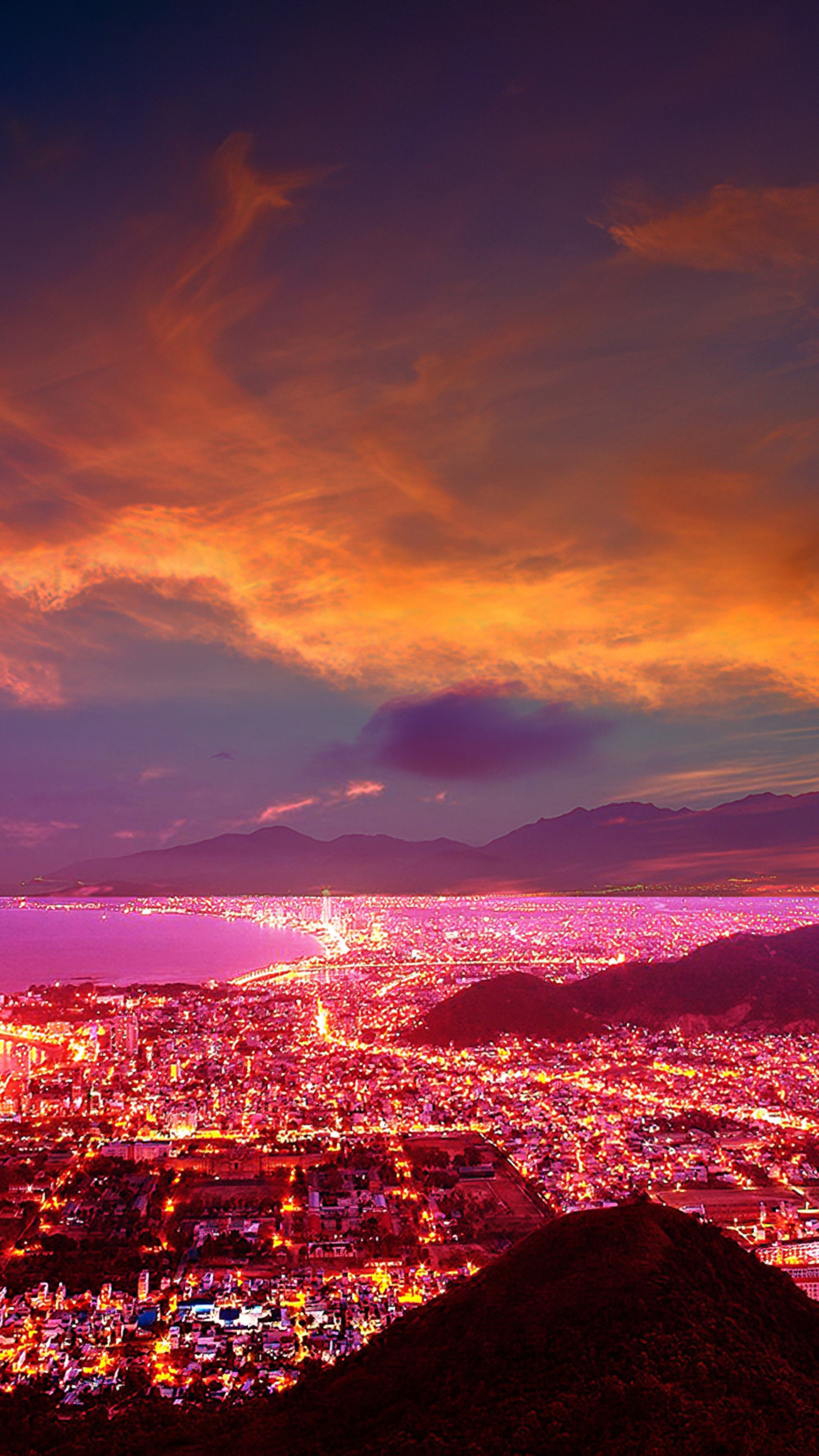 Cityscape at sunset with mountains and ocean HD Phone Wallpaper