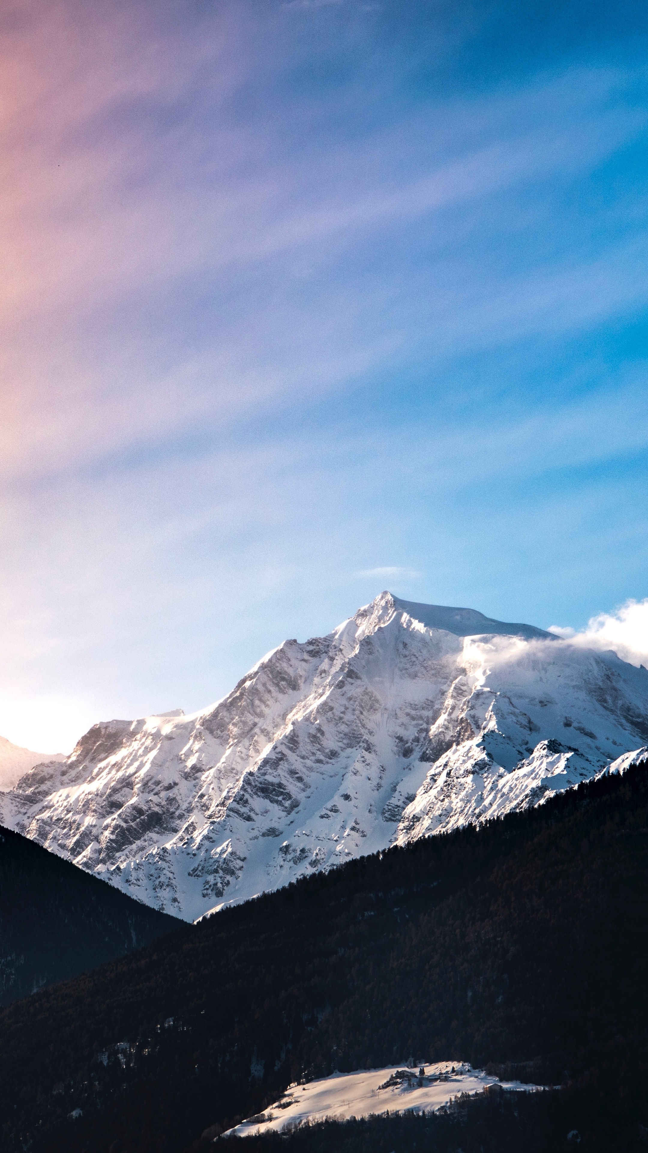 Snow-covered mountains under a colorful sky HD Phone Wallpaper
