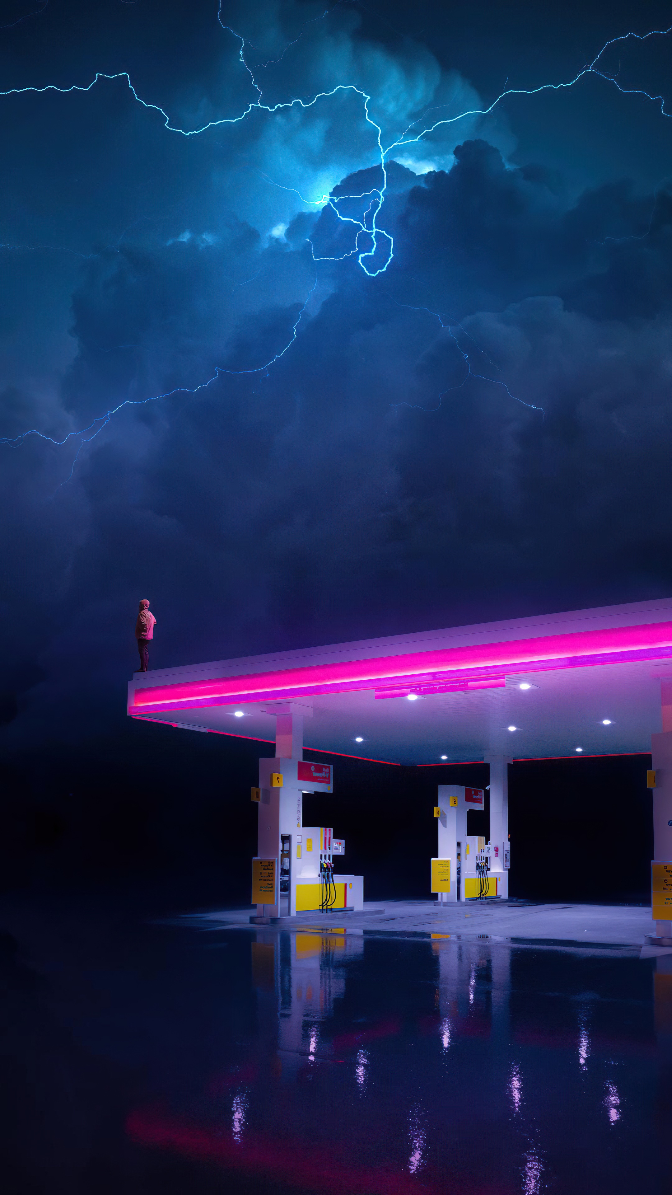 Person on gas station roof during lightning storm HD Phone Wallpaper