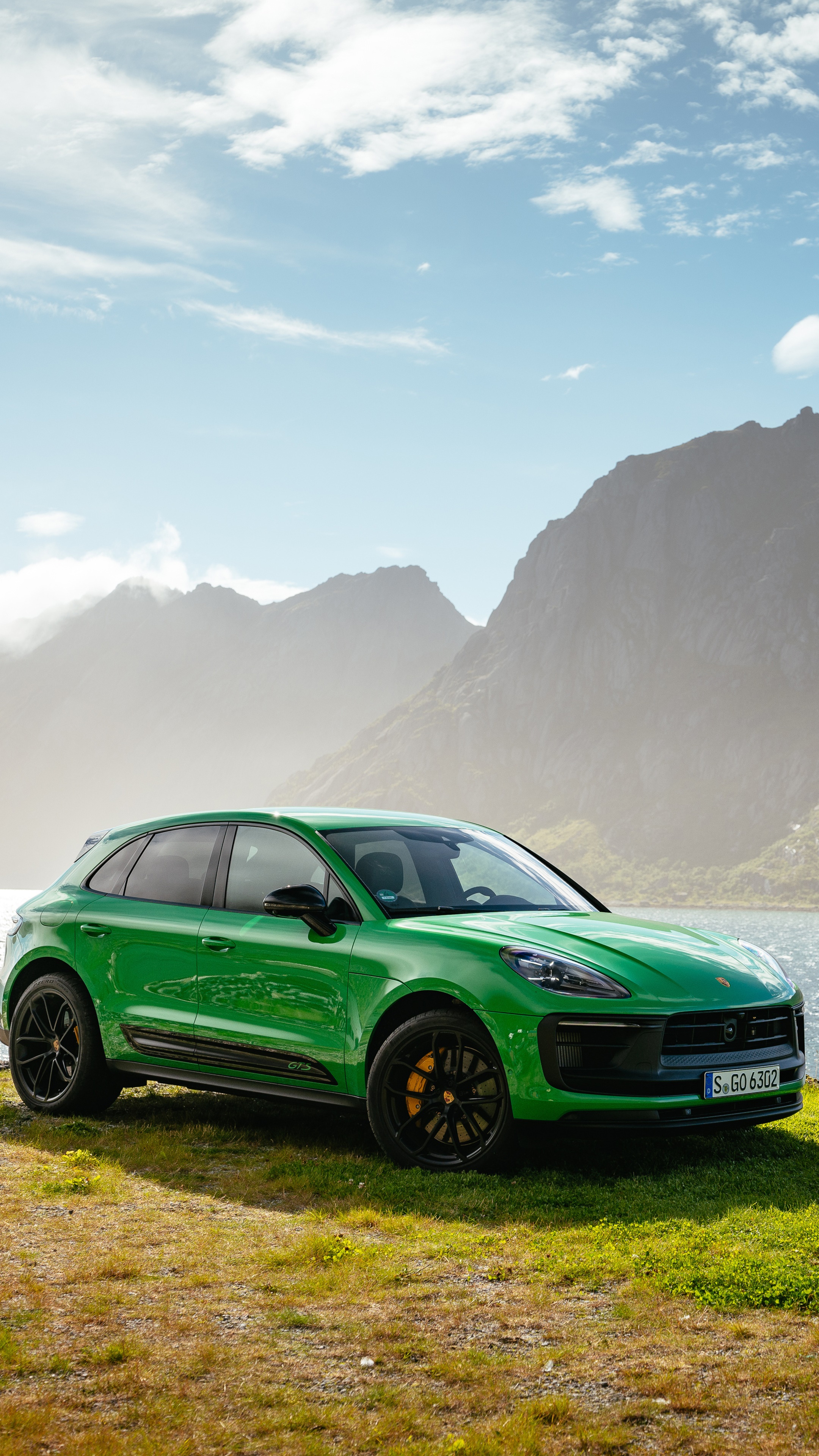 Green Porsche Macan parked on a grassy hill HD Phone Wallpaper