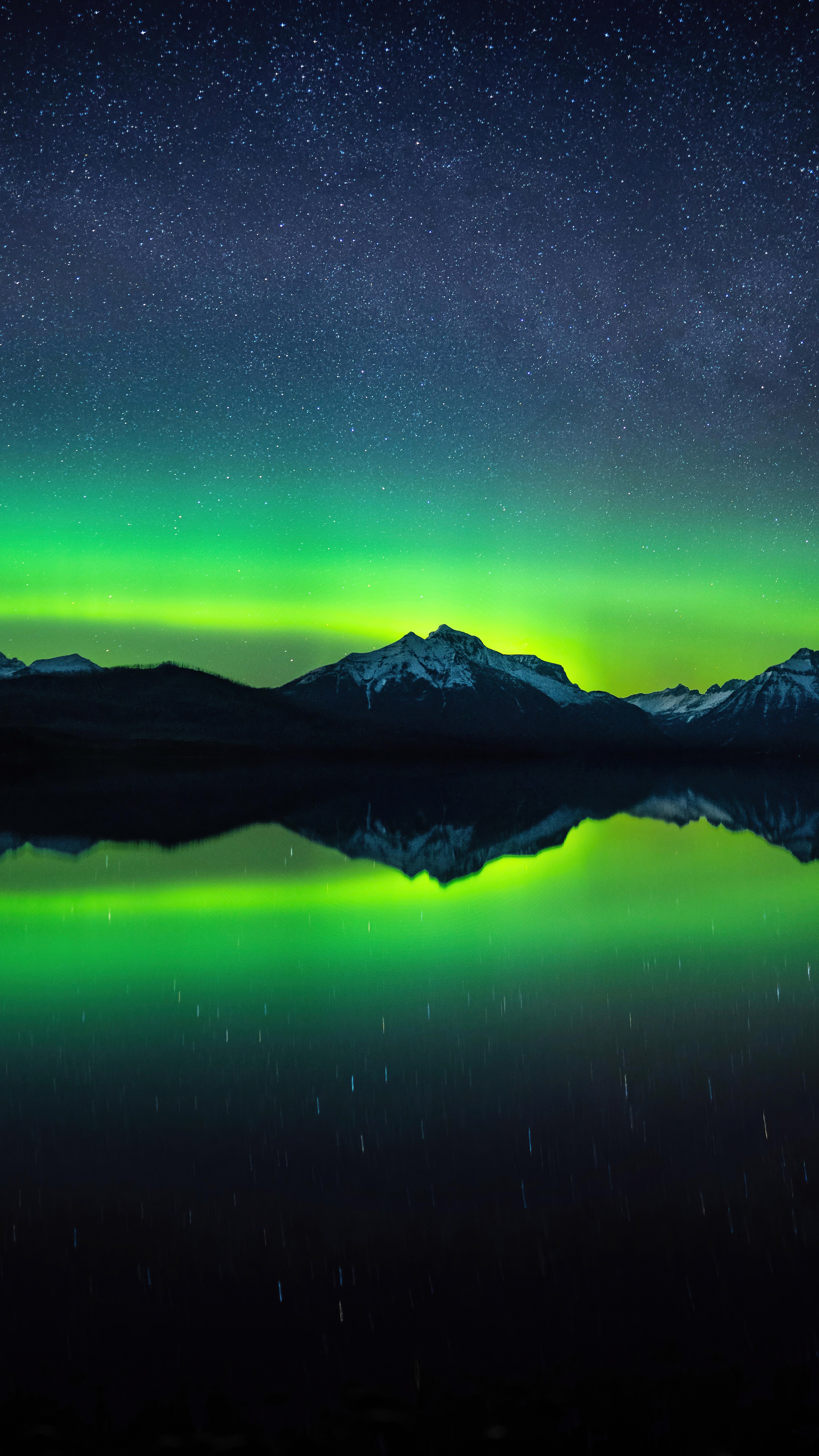 Aurora Borealis over snow-capped mountains reflected in a lake HD Phone Wallpaper