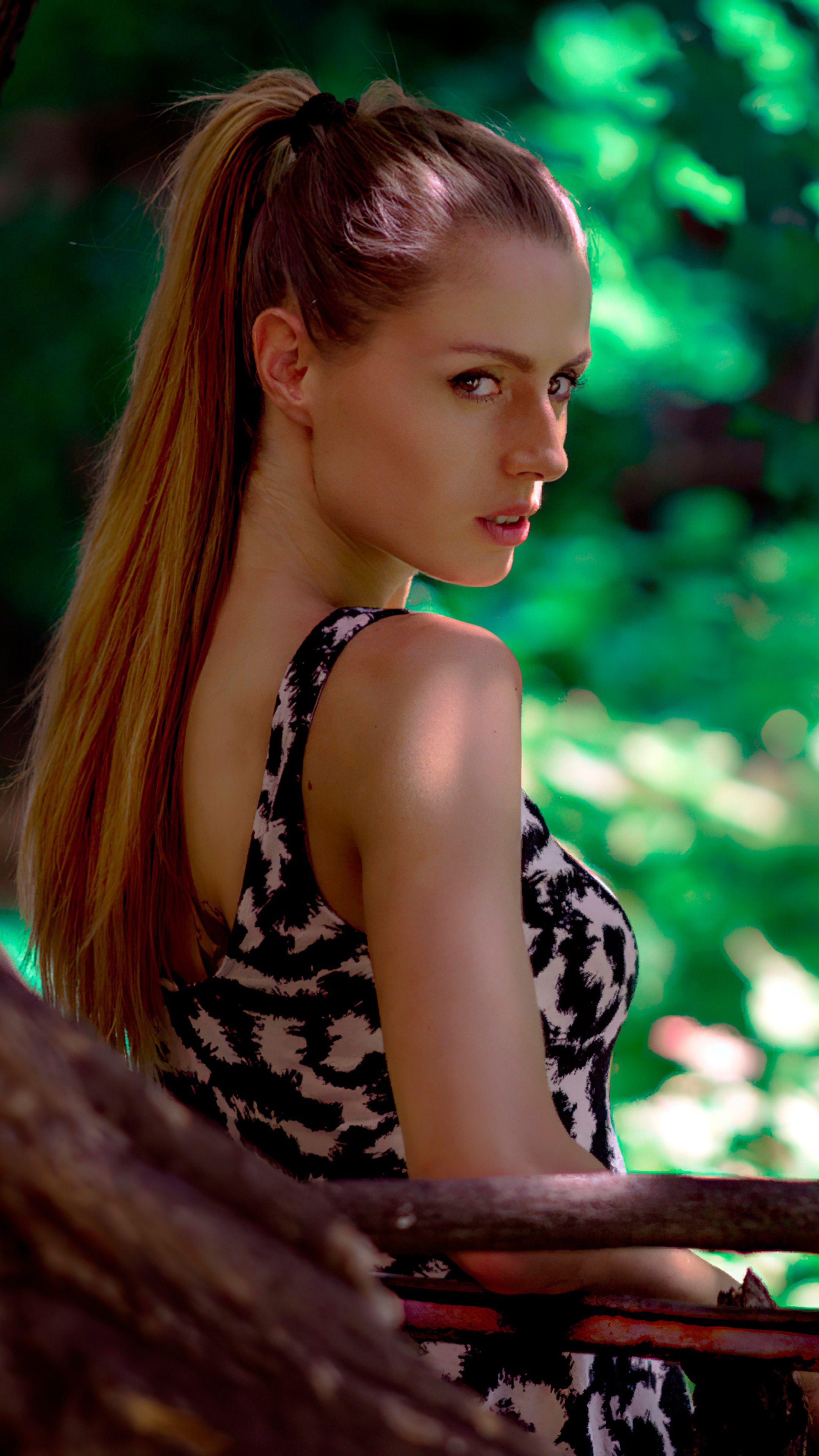 Woman with ponytail in a patterned dress HD Phone Wallpaper