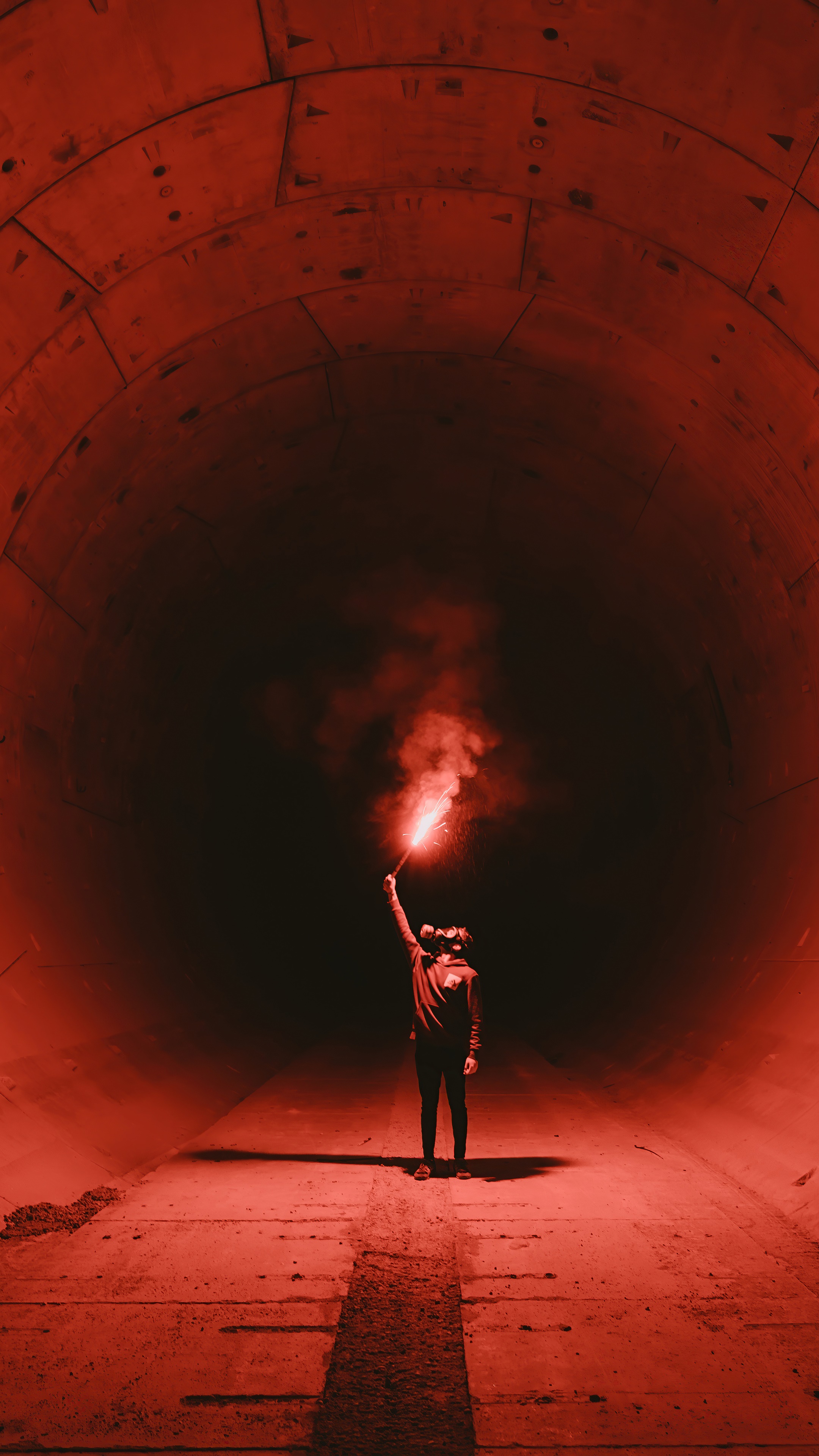 Person holding a red flare in a tunnel HD Phone Wallpaper