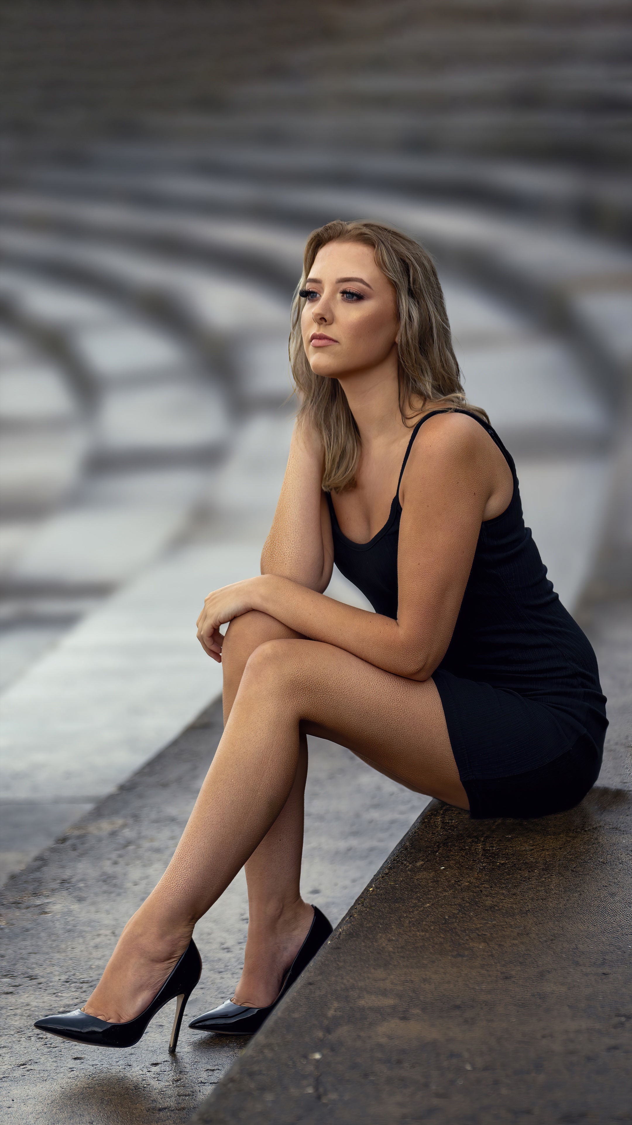Woman in black dress sitting on wet stairs HD Phone Wallpaper