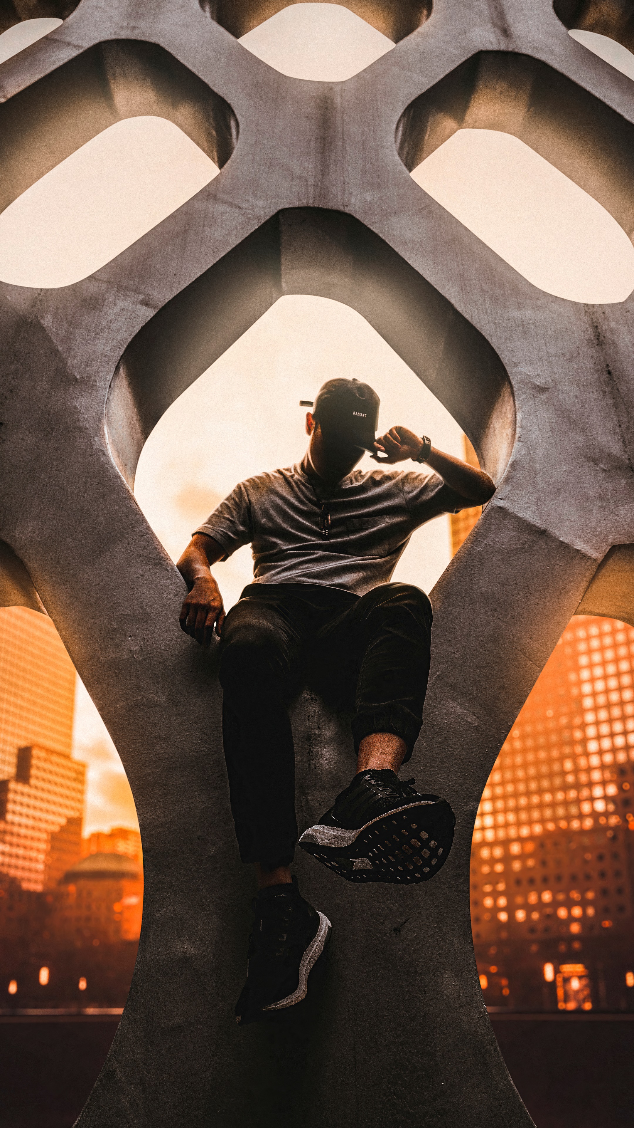 Man sitting on concrete structure 4K HD Phone Wallpaper