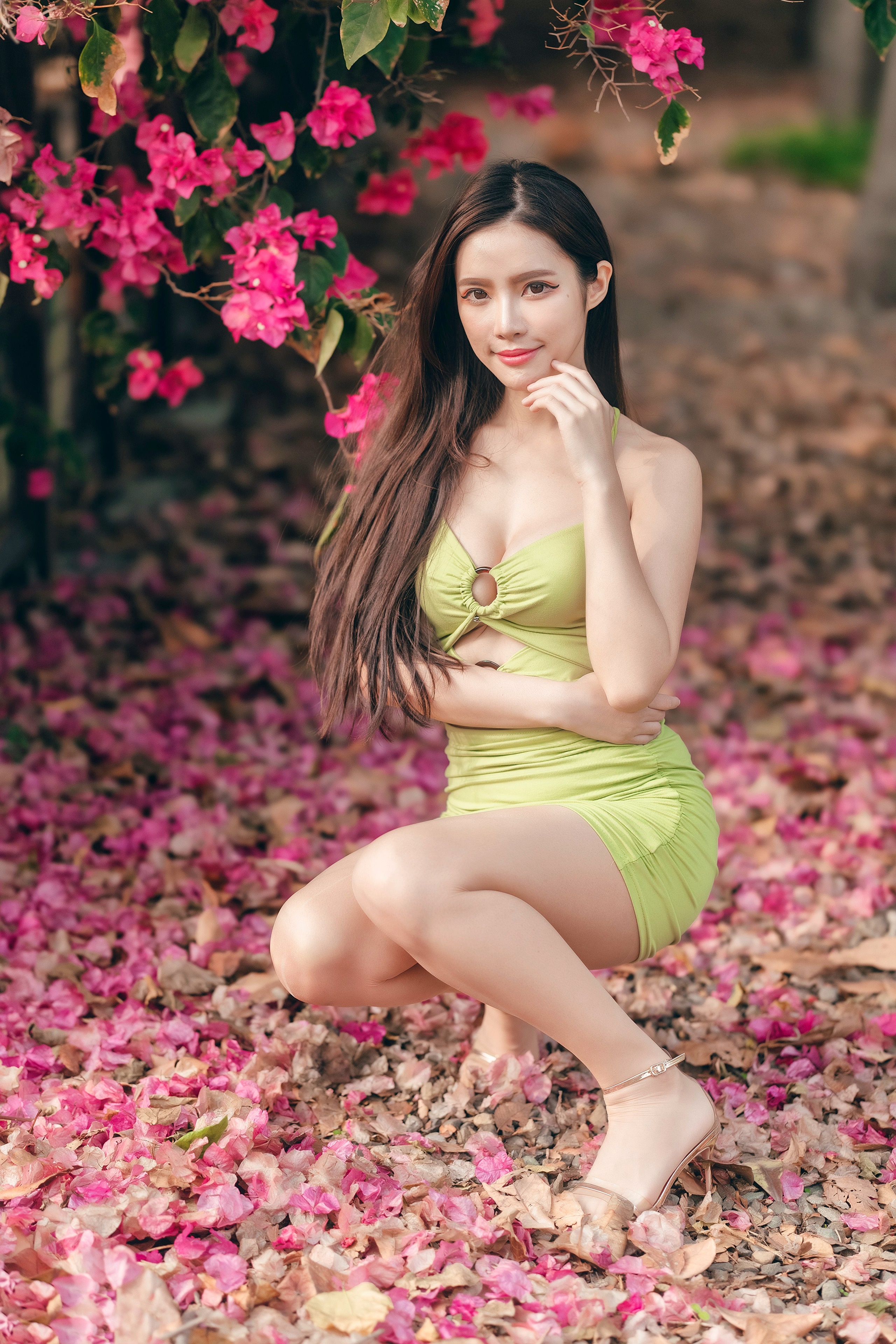 Asian woman in a green dress posing outdoors HD Phone Wallpaper