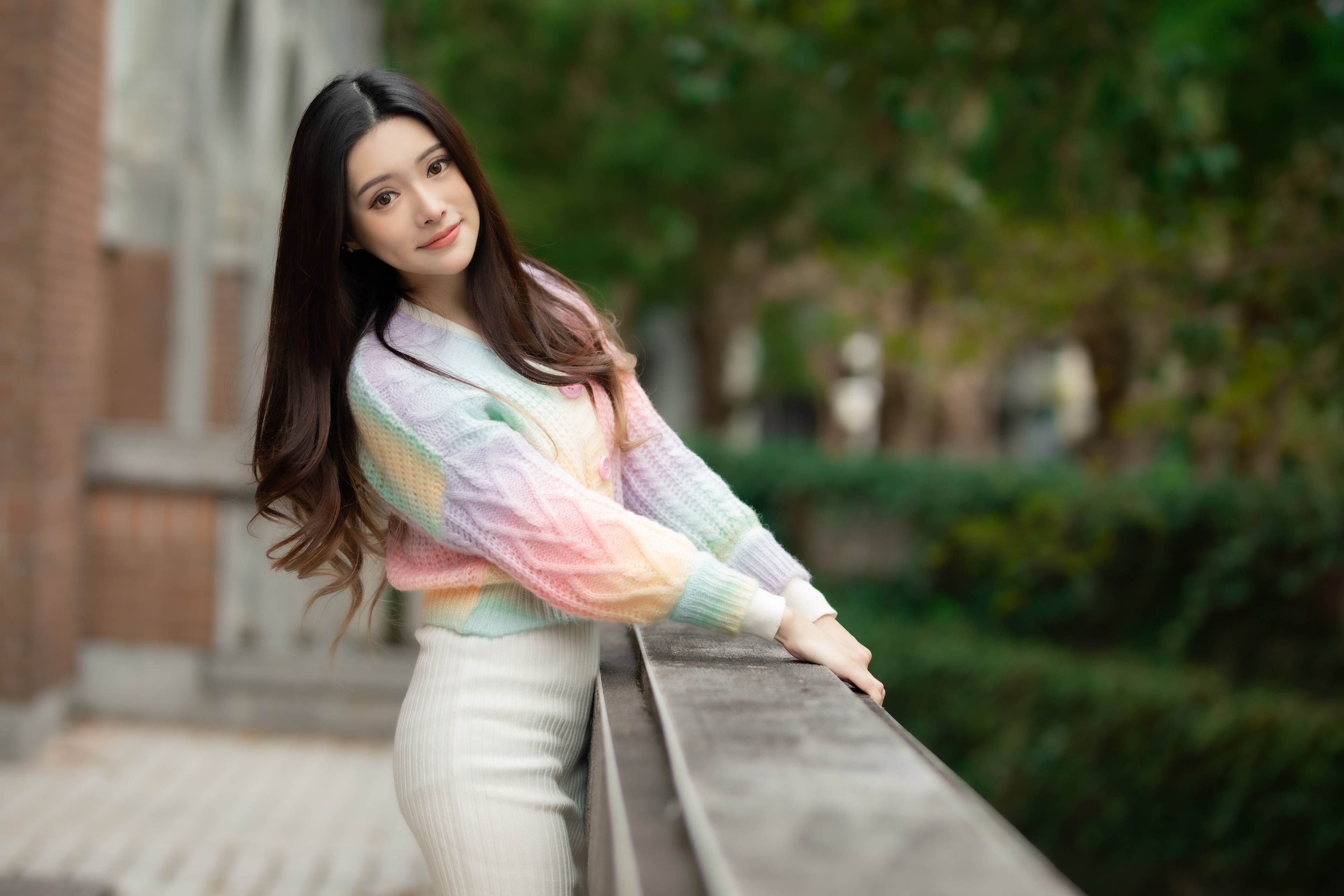 Asian woman in a colorful sweater and white skirt HD Wallpaper