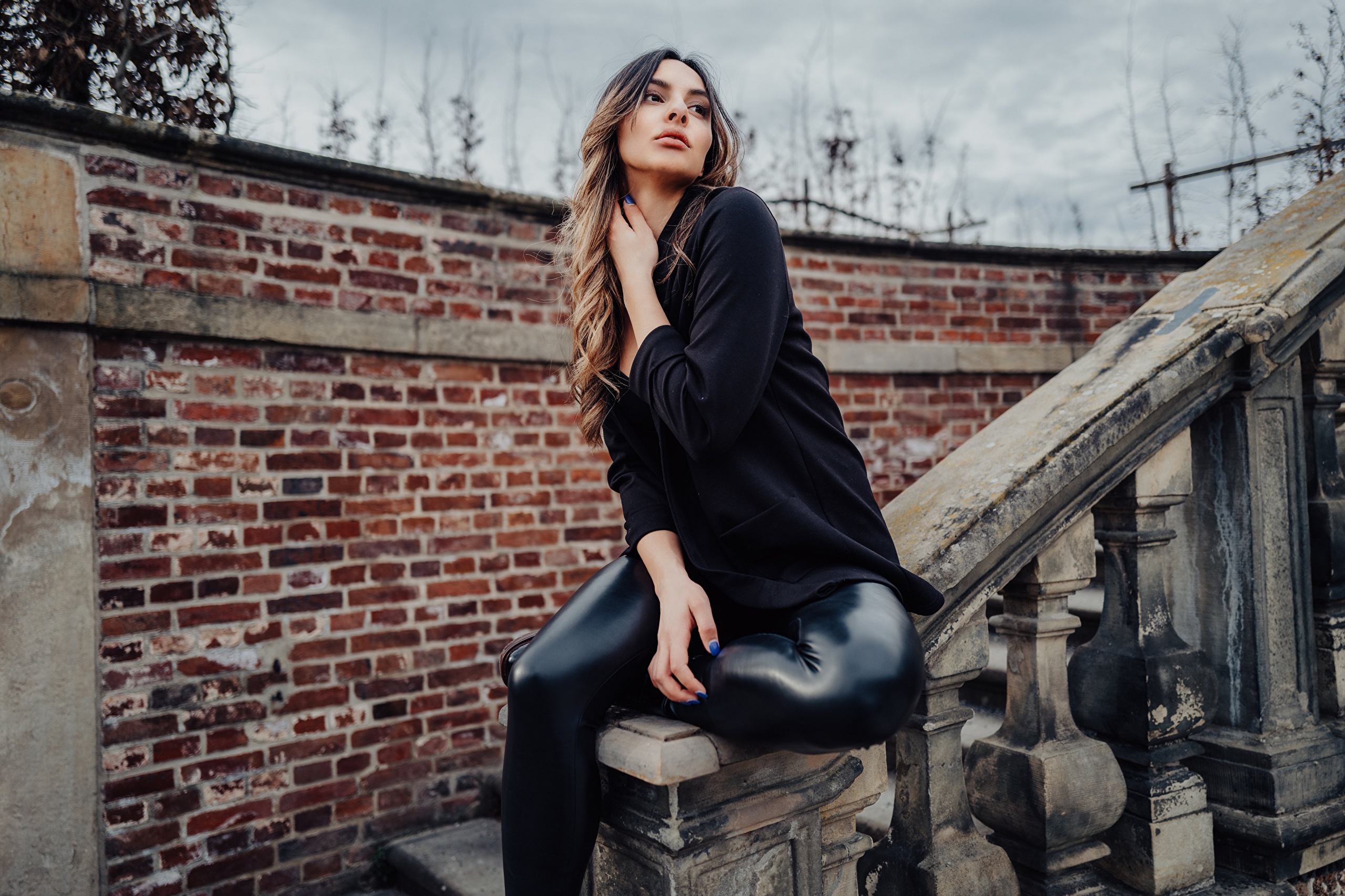 Woman in black suit jacket and leather pants sitting on stairs HD Wallpaper