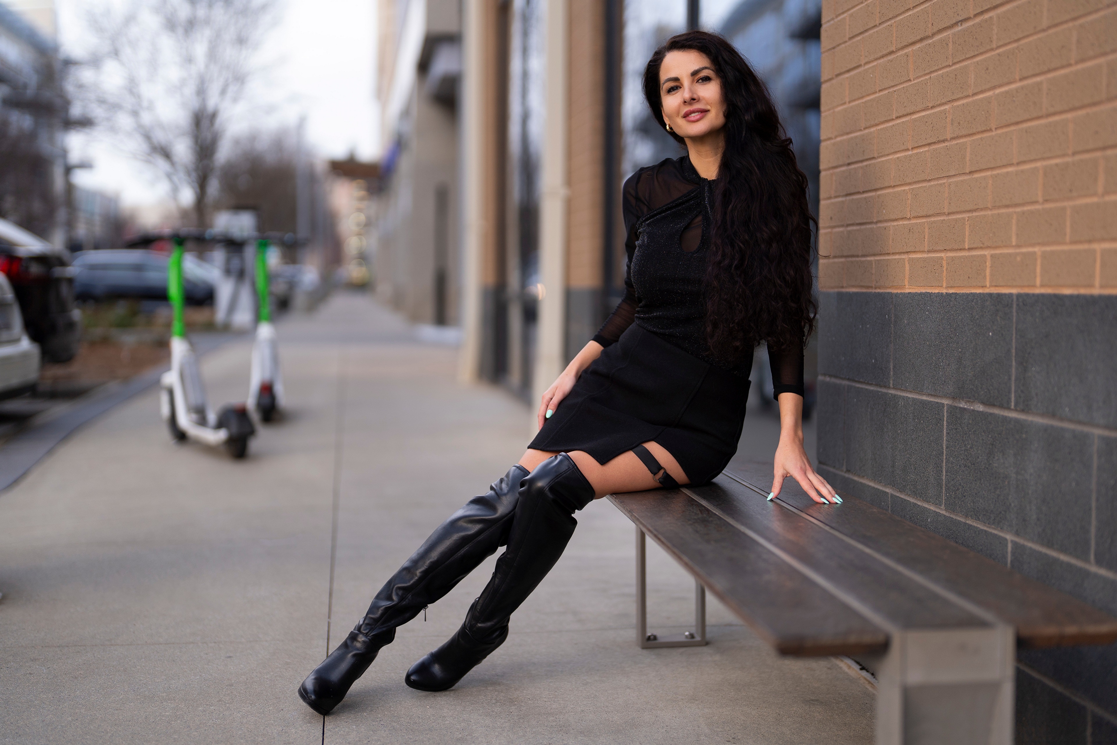 Victoria Bell sitting on a bench wearing boots HD Wallpaper