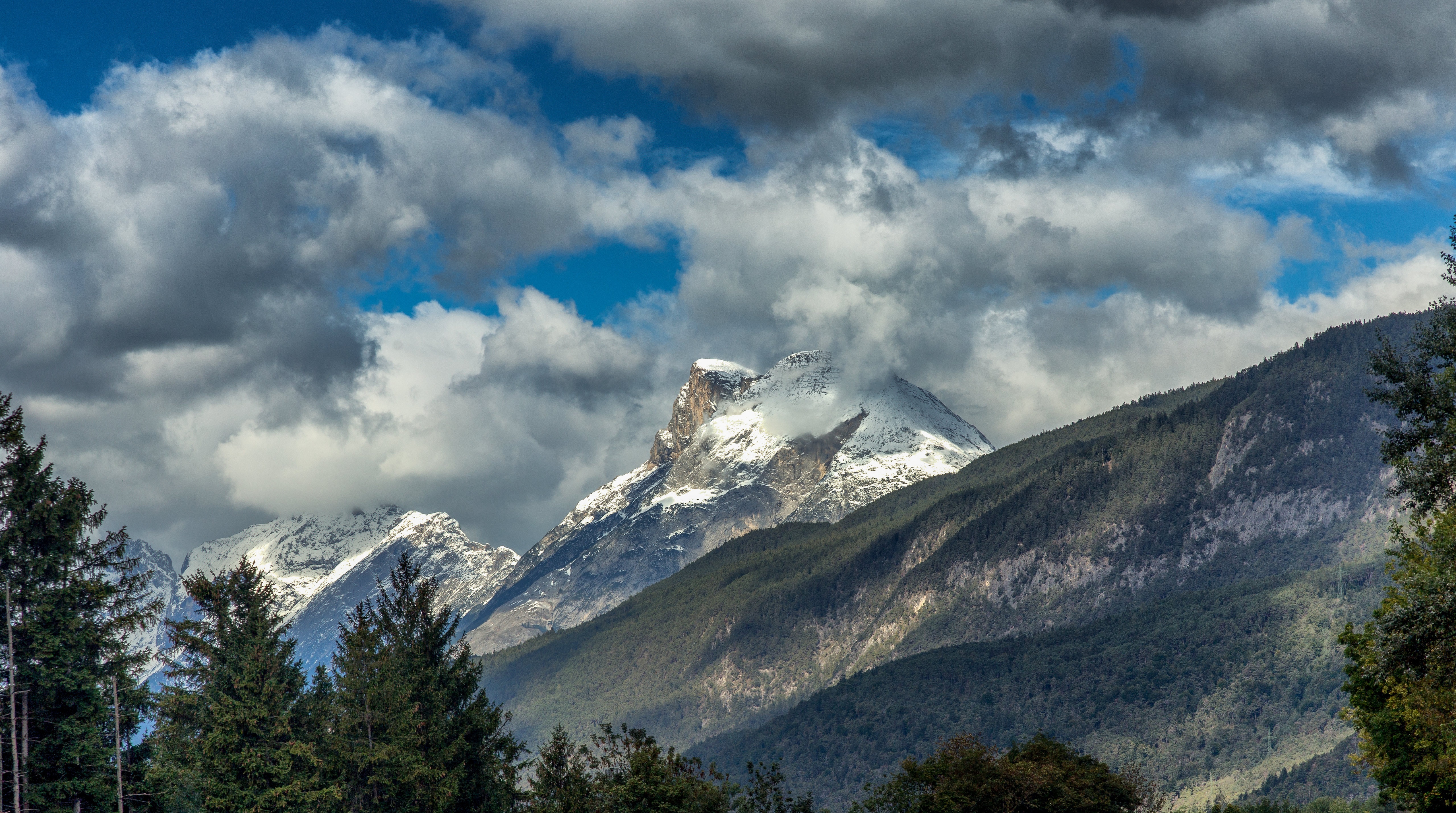 Snow-capped Dolomites mountains in Italy under clouds HD Wallpaper