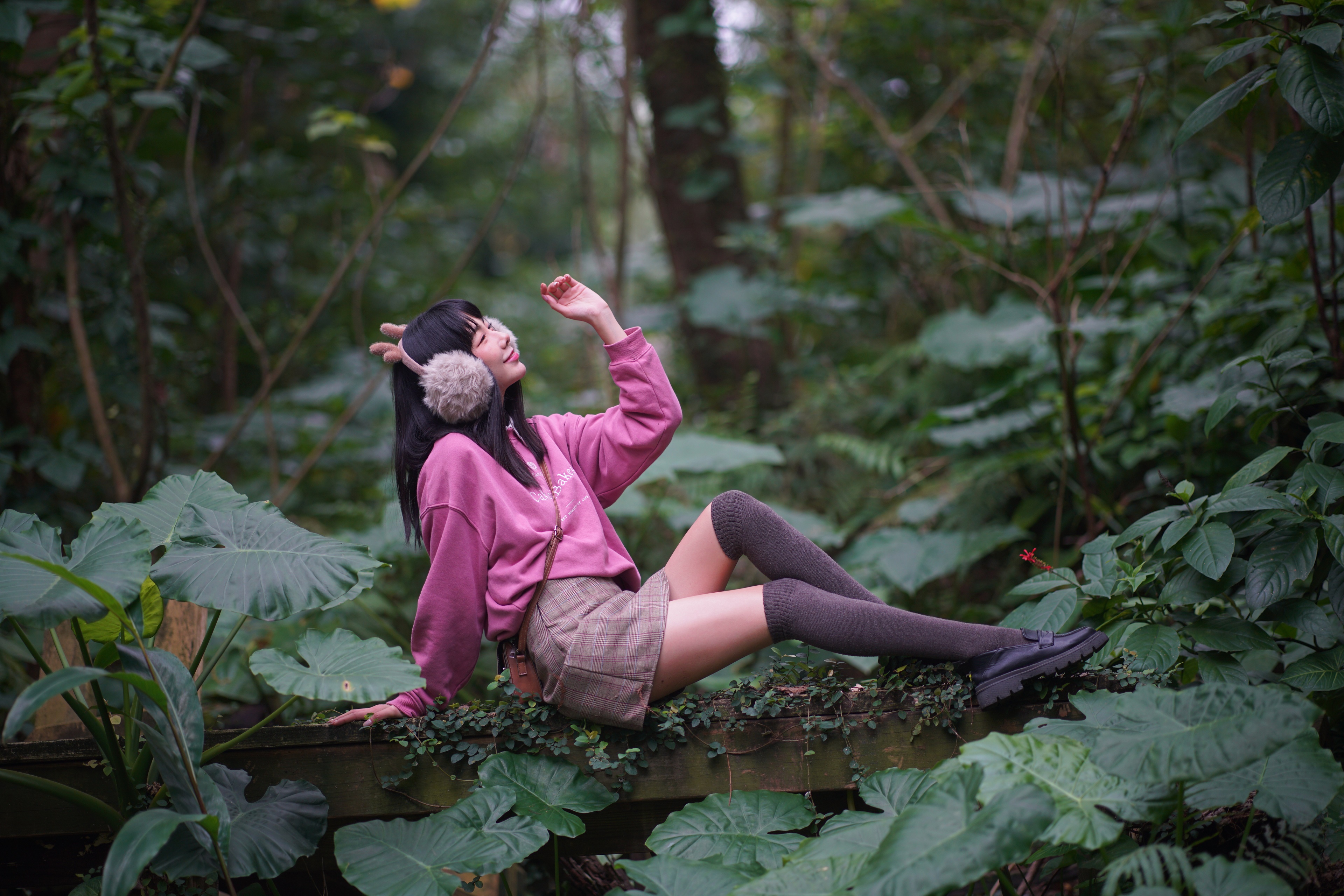 Brunette girl in knee-highs and skirt posing in forest HD Wallpaper
