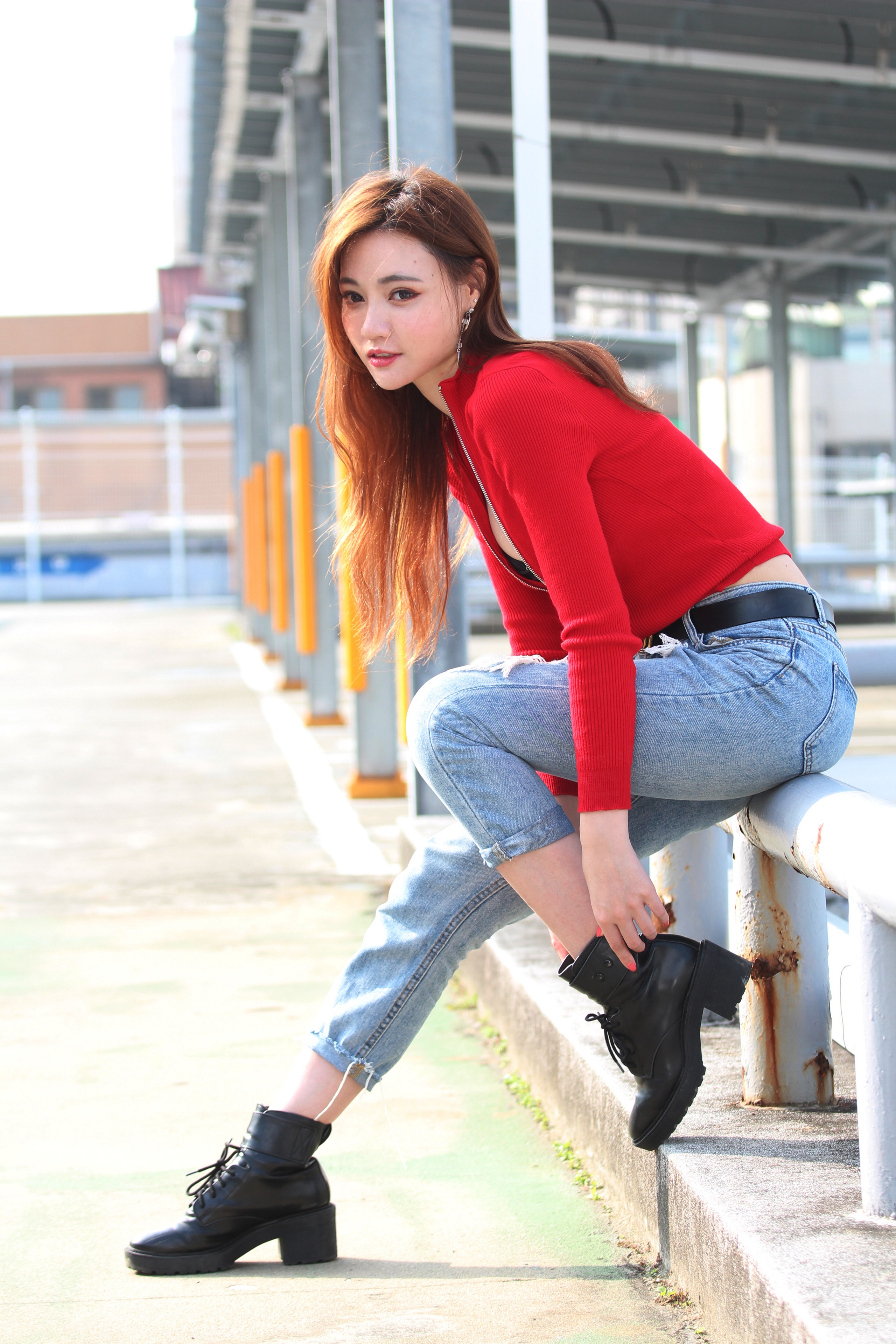 Asian woman in red top and jeans posing outdoors HD Phone Wallpaper