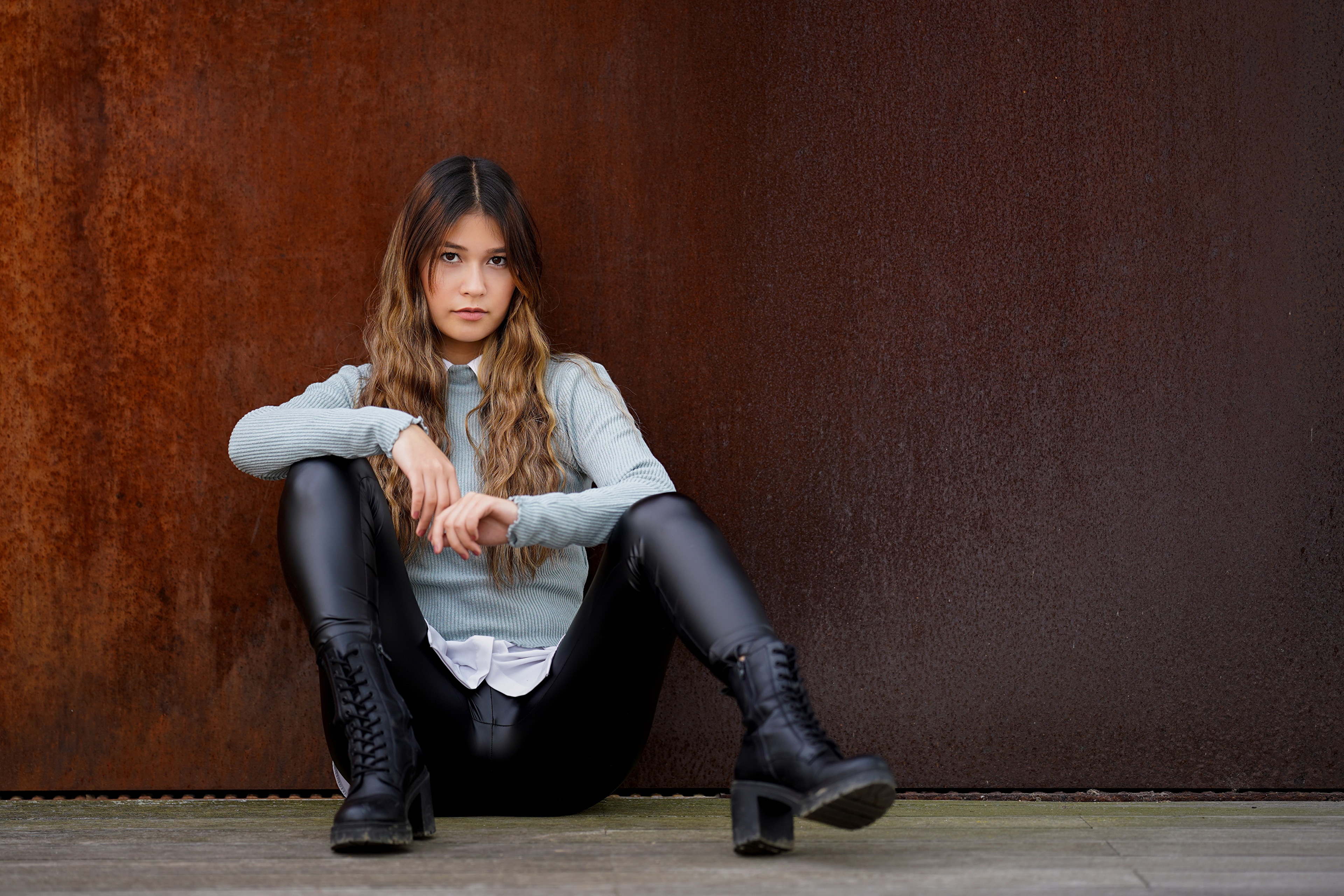 Jennifer sitting in black trousers and boots HD Wallpaper
