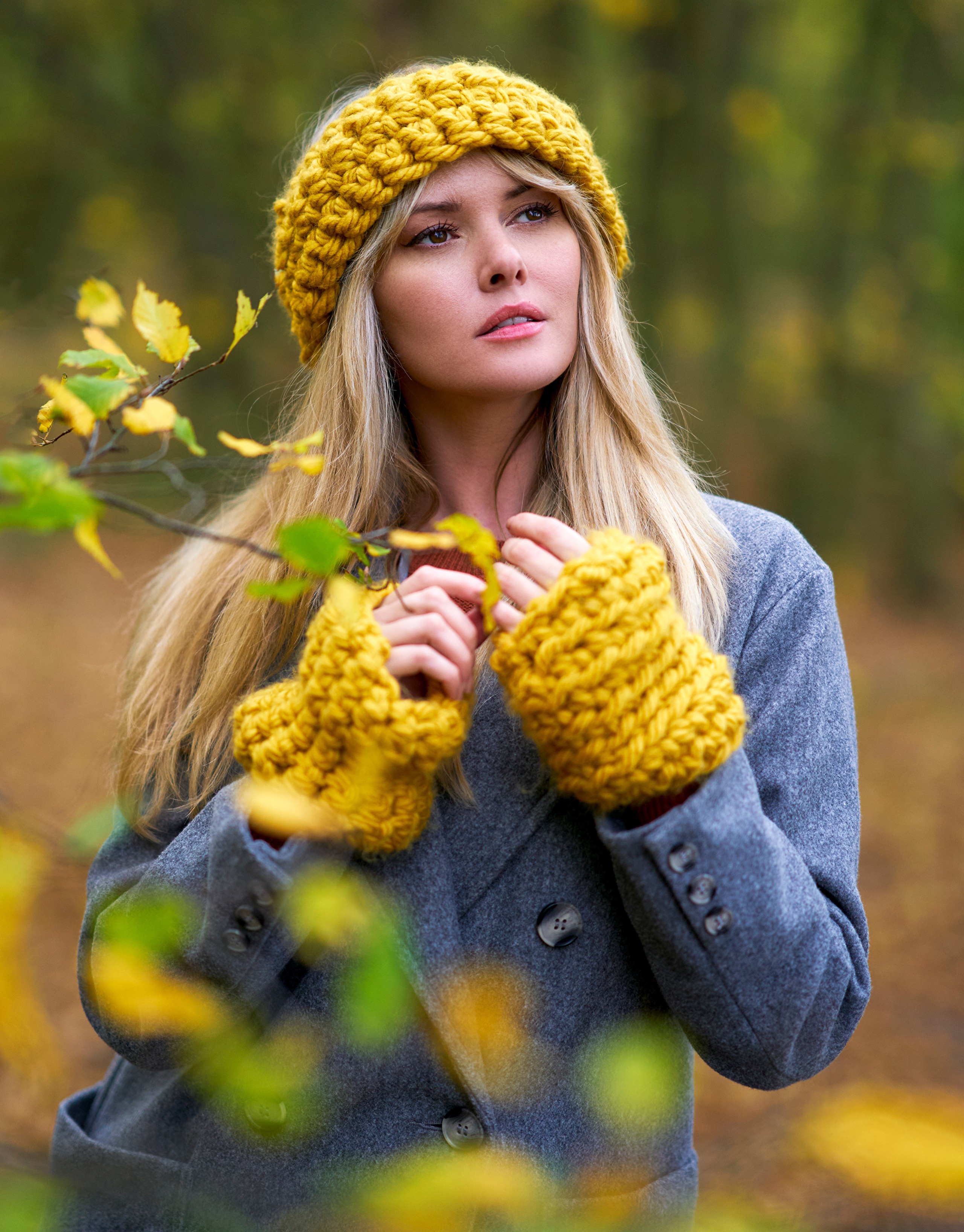 Blonde woman wearing a yellow knitted headband and coat HD Phone Wallpaper