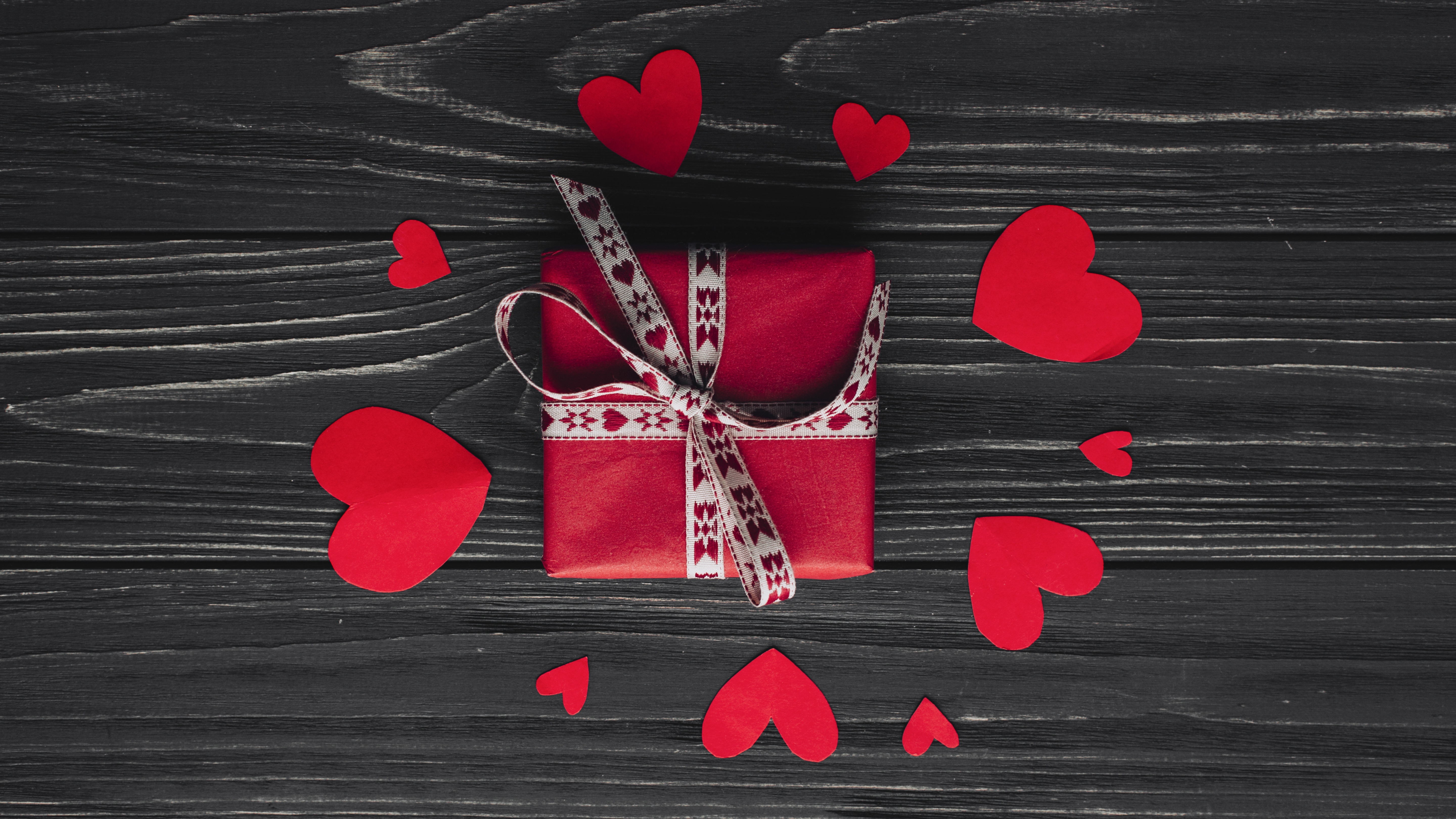 Red gift box with hearts on wood planks HD Wallpaper