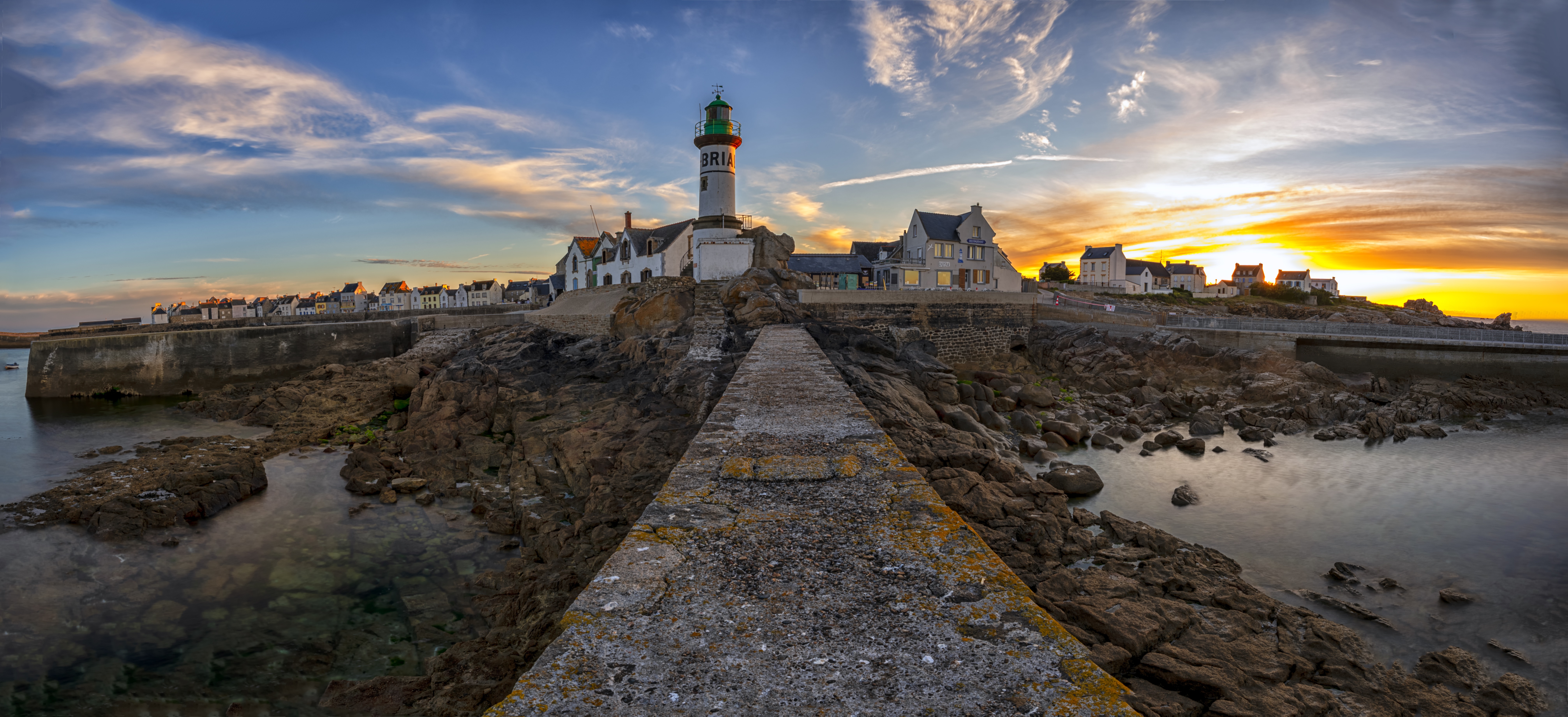 Lighthouse and village on Enez Sun island at sunset, France HD Wallpaper