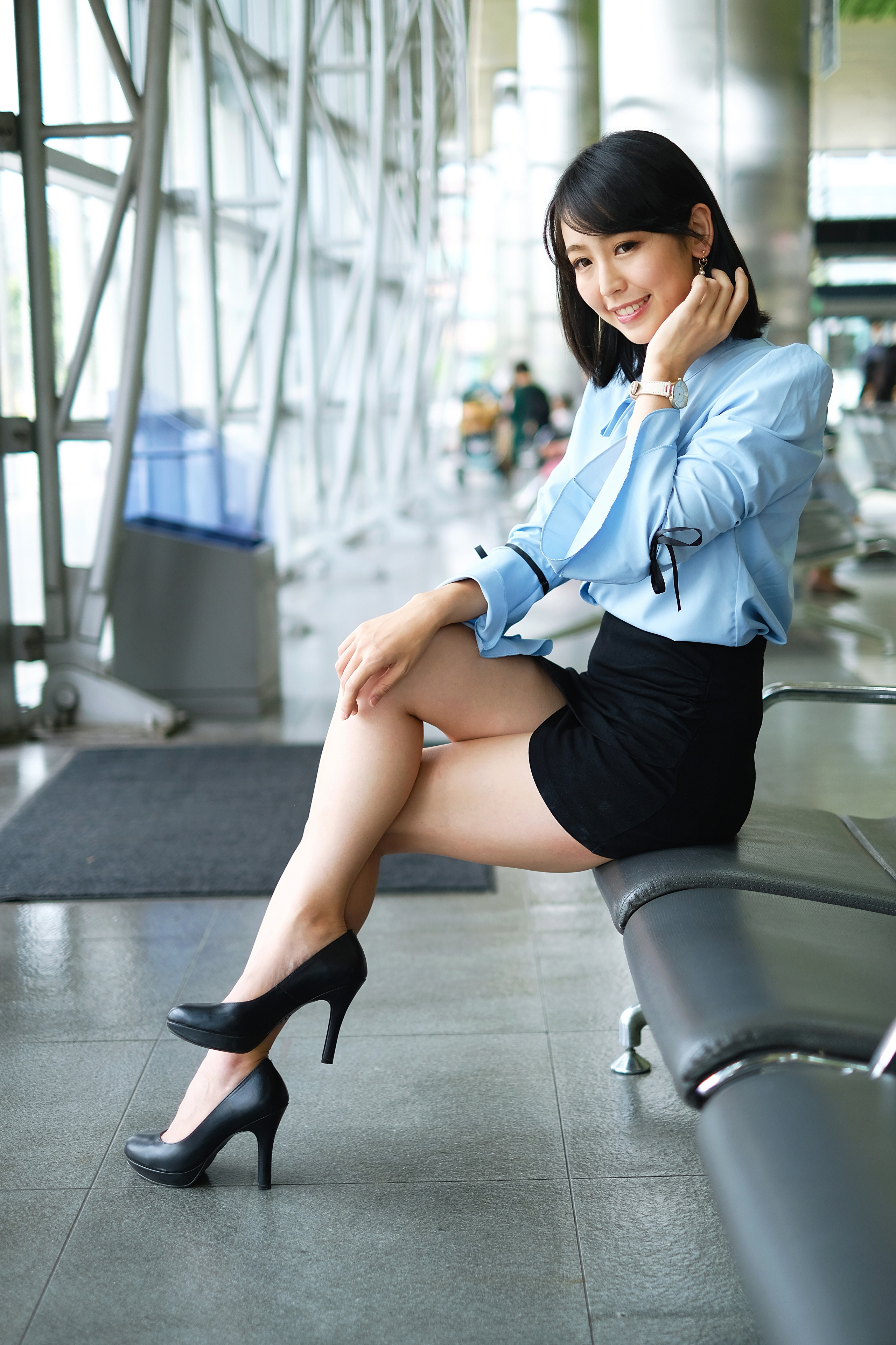 Asian woman in blue blouse and black skirt sitting on bench HD Phone Wallpaper
