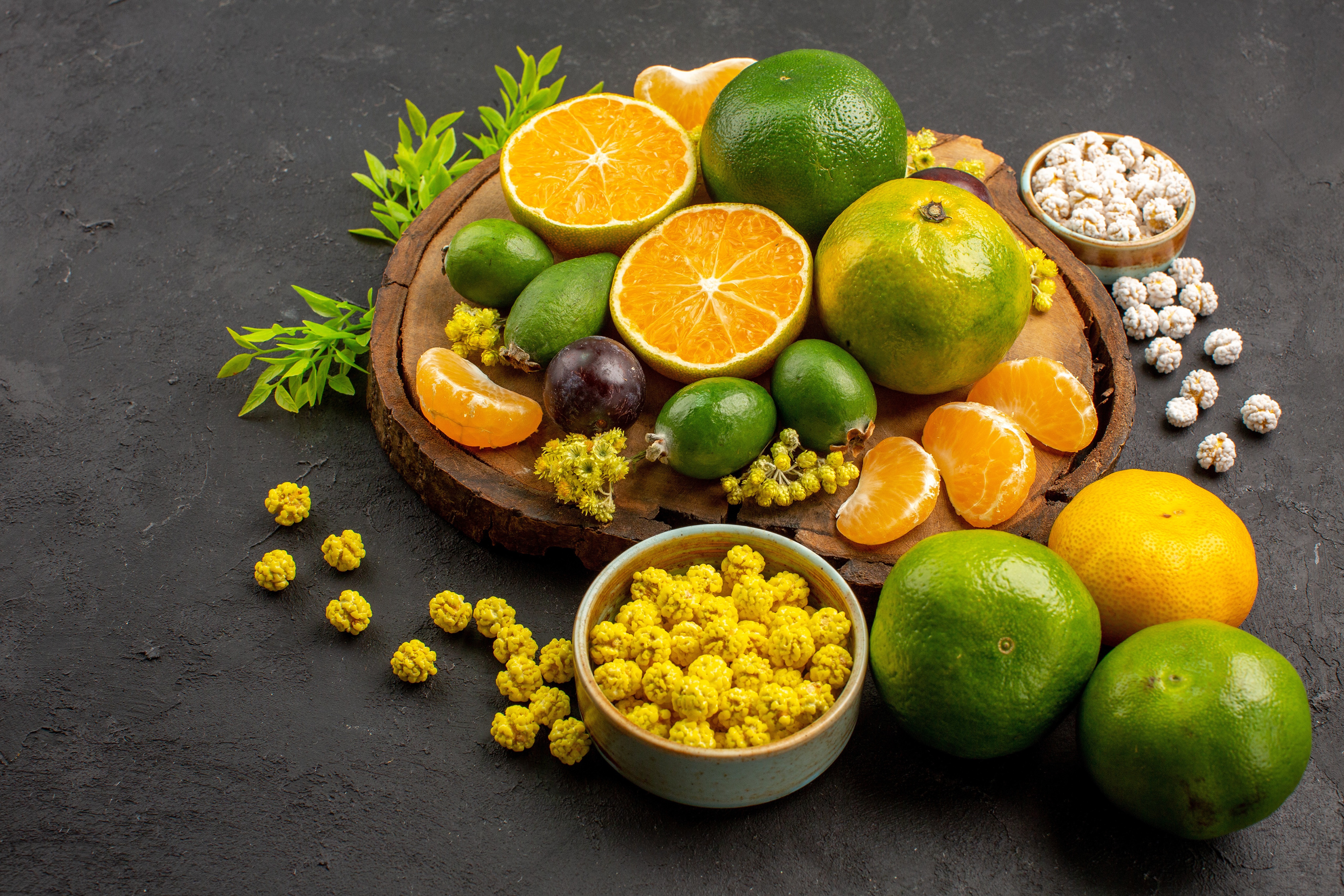Citrus fruits and snacks on a wooden board HD Wallpaper