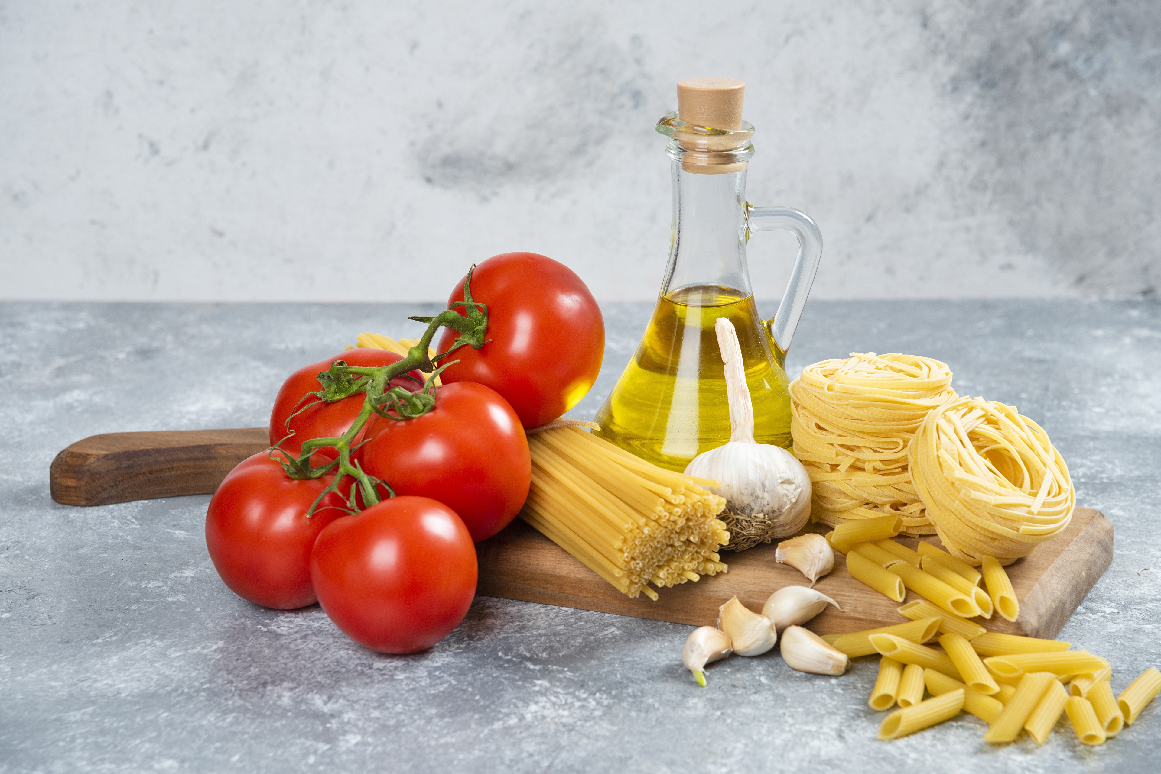 Tomatoes, Garlic, Oil, and Pasta on Cutting Board HD Wallpaper