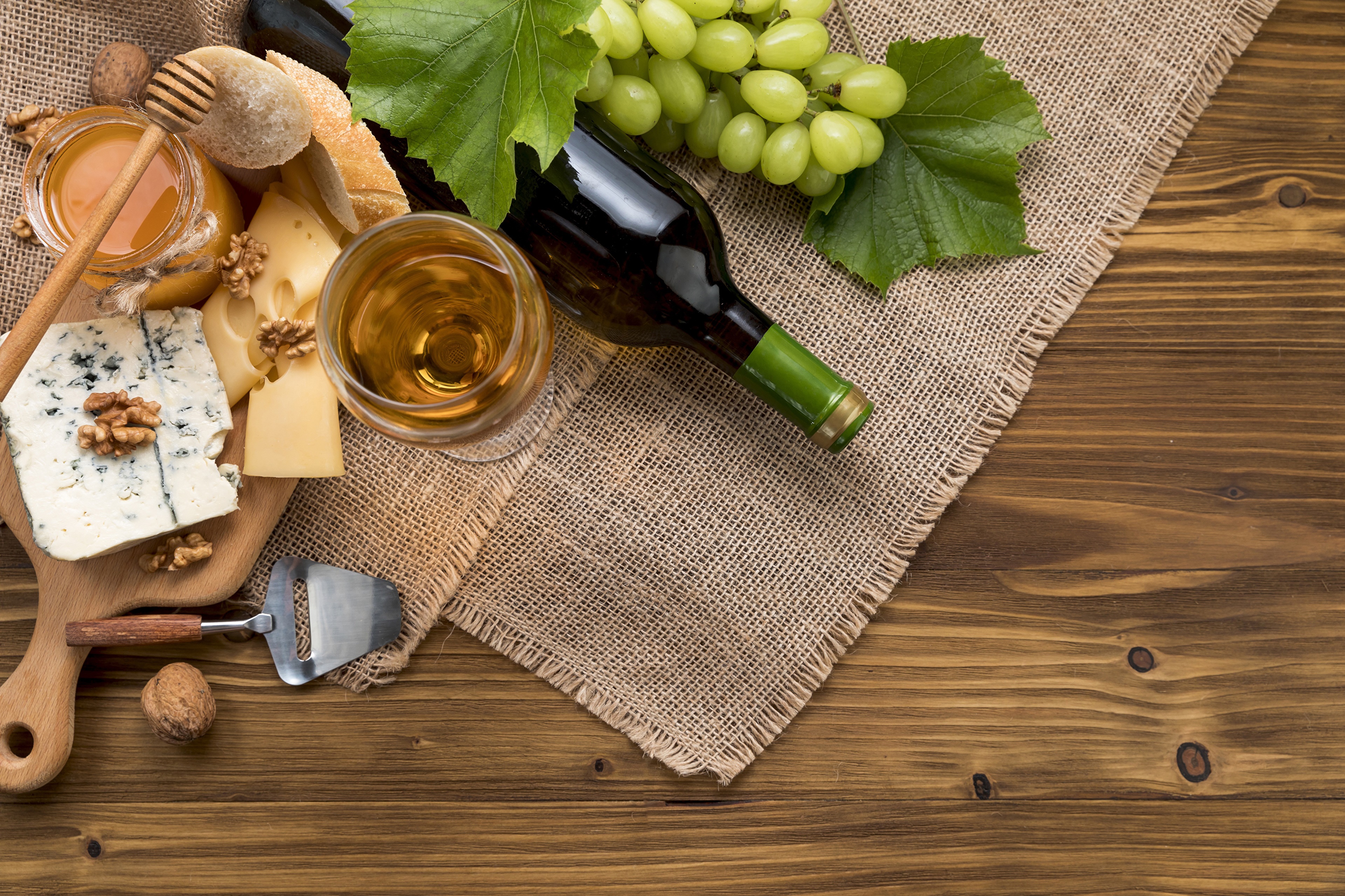 Wine, Cheese, Grapes, Bread, Honey, and Walnuts on a Cutting Board HD Wallpaper