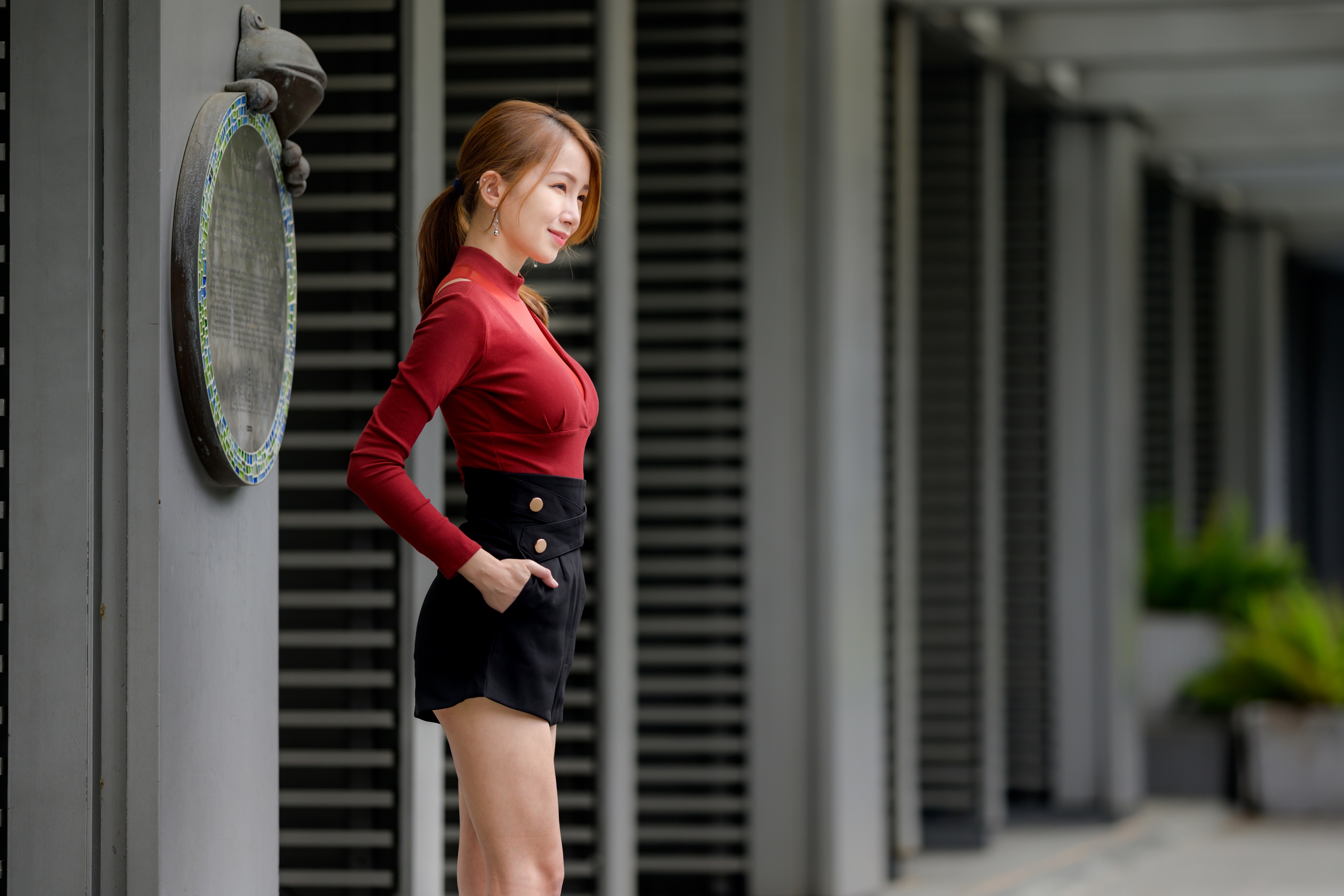Asian woman in red blouse and black shorts HD Wallpaper