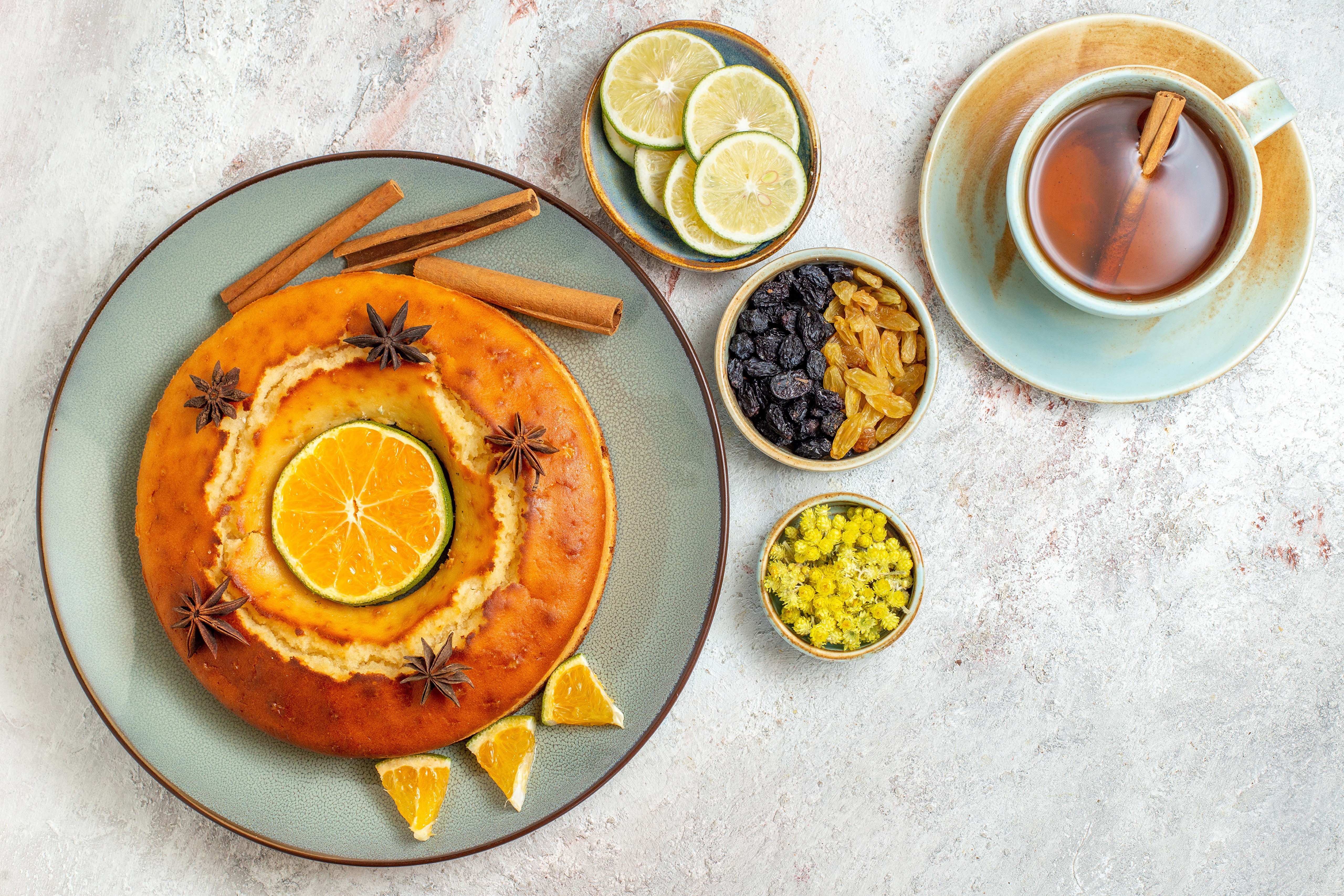 Cake with orange, cinnamon, lime, raisins, and tea HD Wallpaper