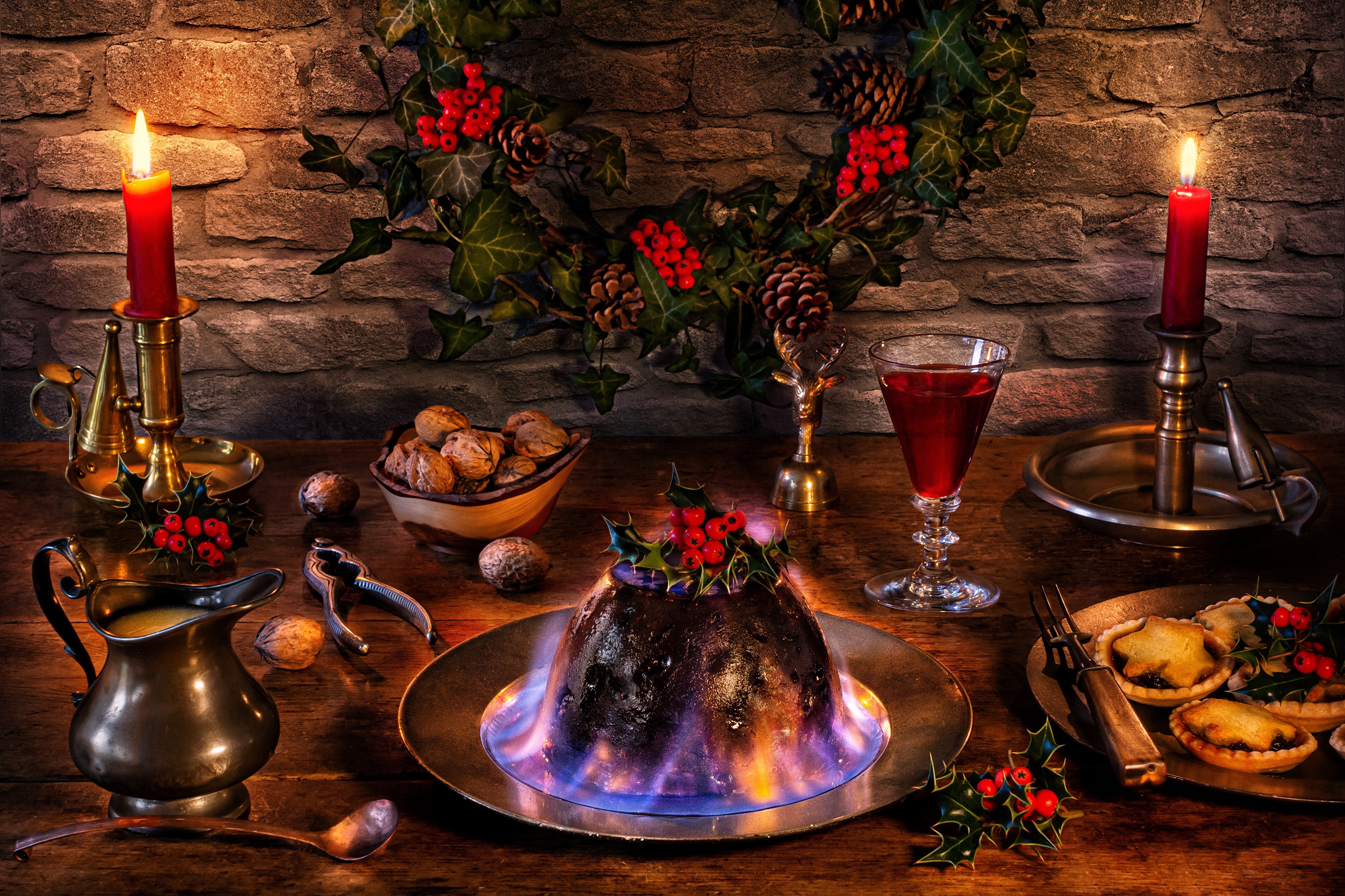 Christmas pudding with flaming brandy, nuts, and mince pies HD Wallpaper