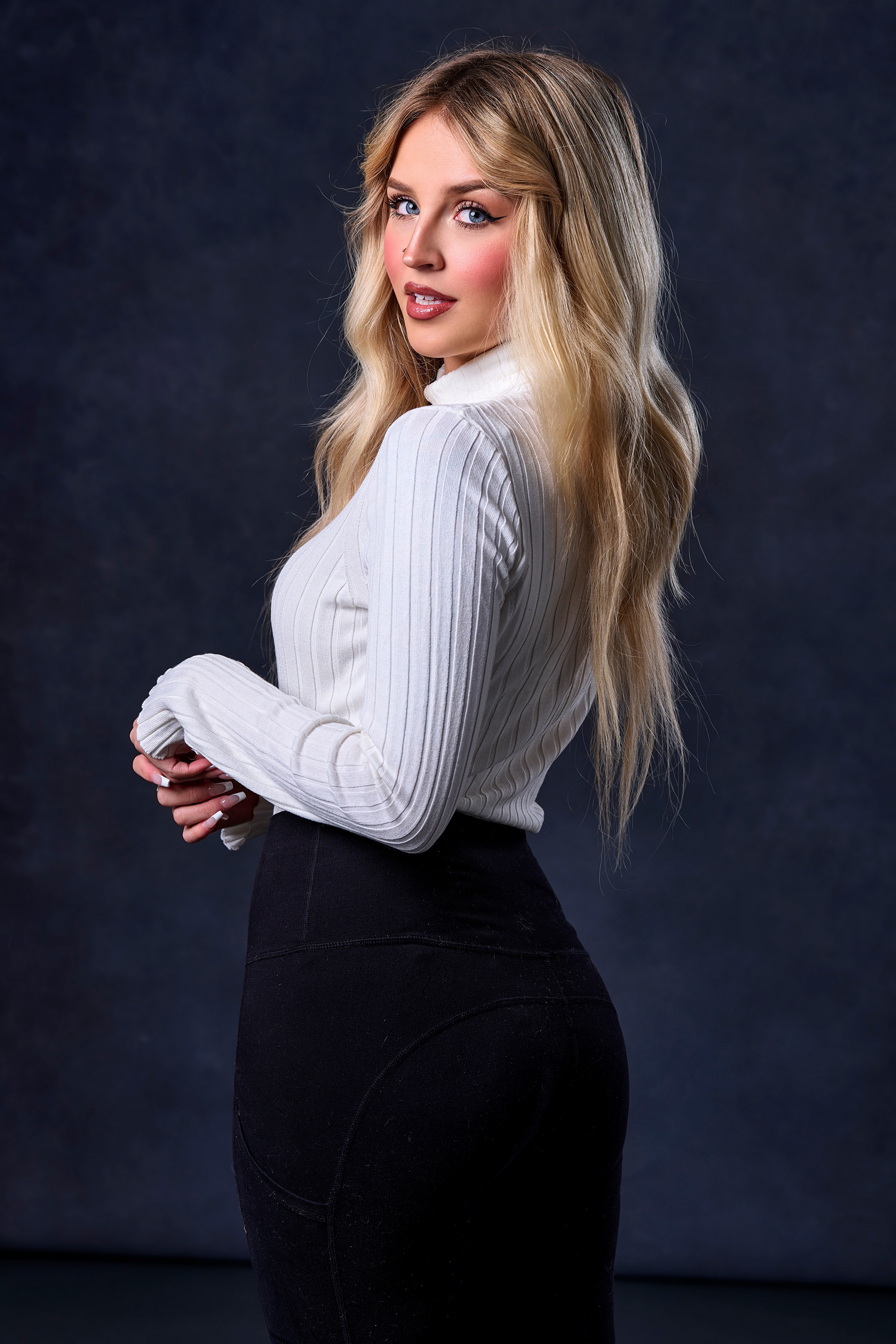 Blonde woman in white sweater and black pants HD Phone Wallpaper