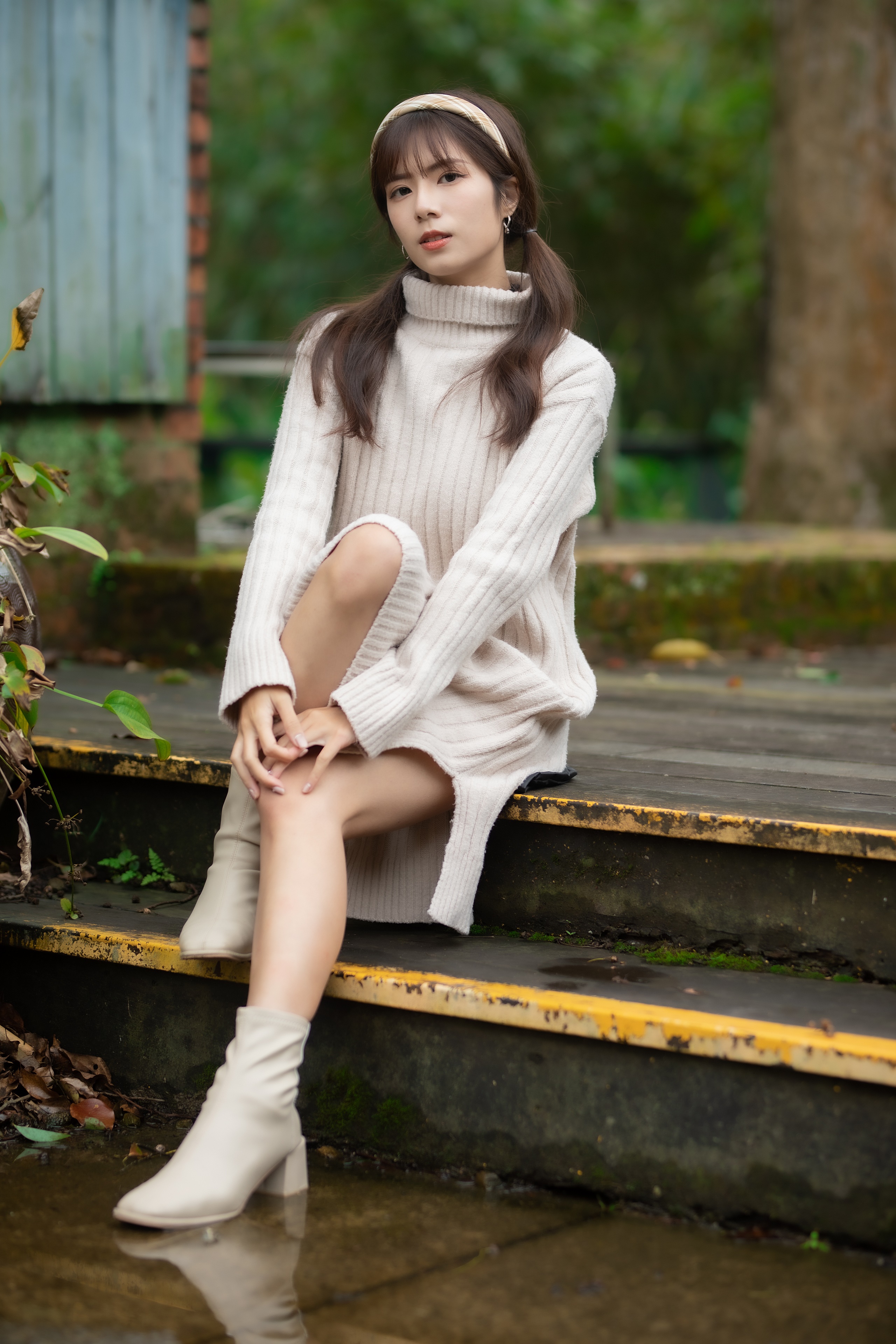 Asian woman in a cream sweater dress sitting on steps HD Phone Wallpaper