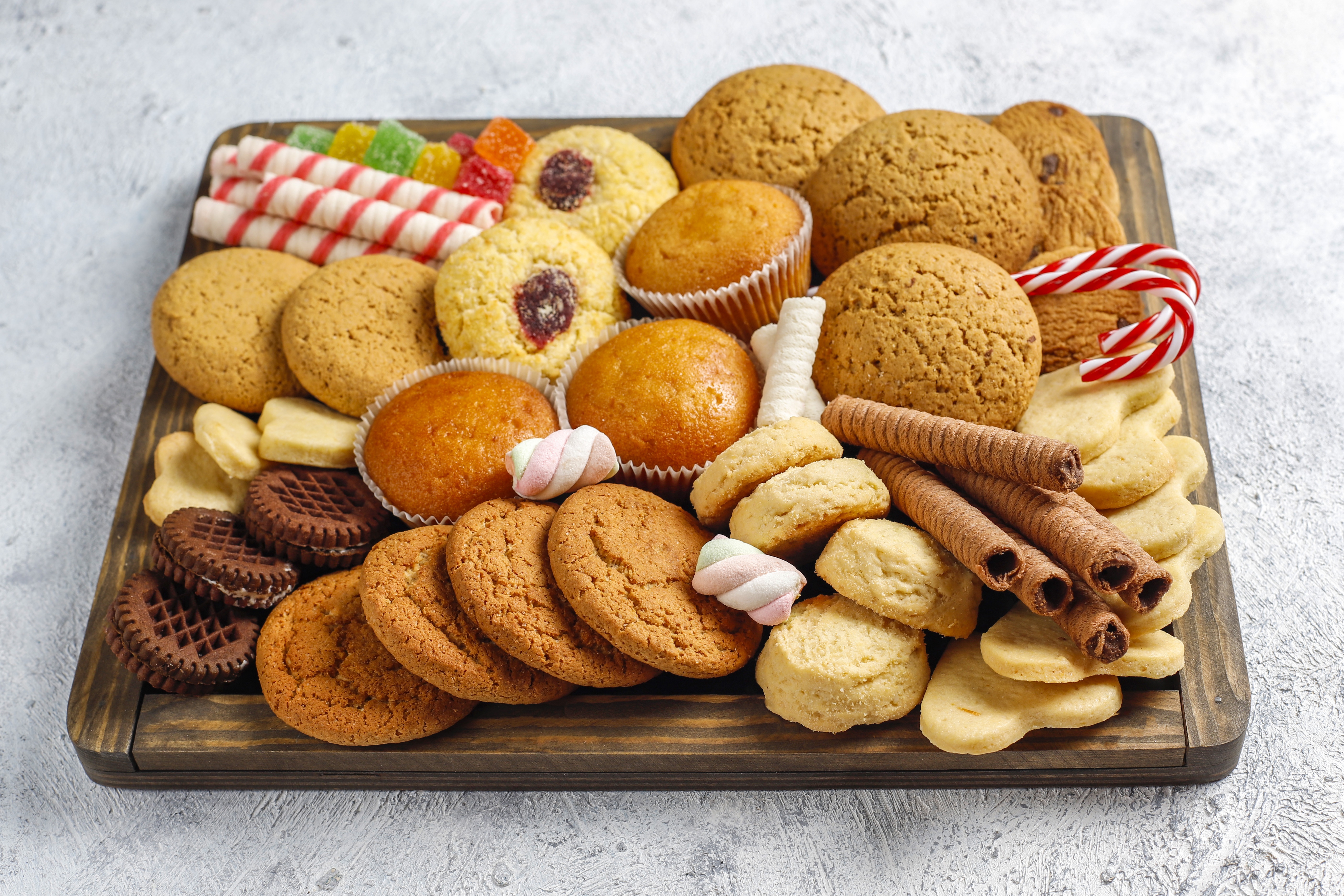 Assortment of Cookies, Muffins, and Candies on a Wooden Tray HD Wallpaper