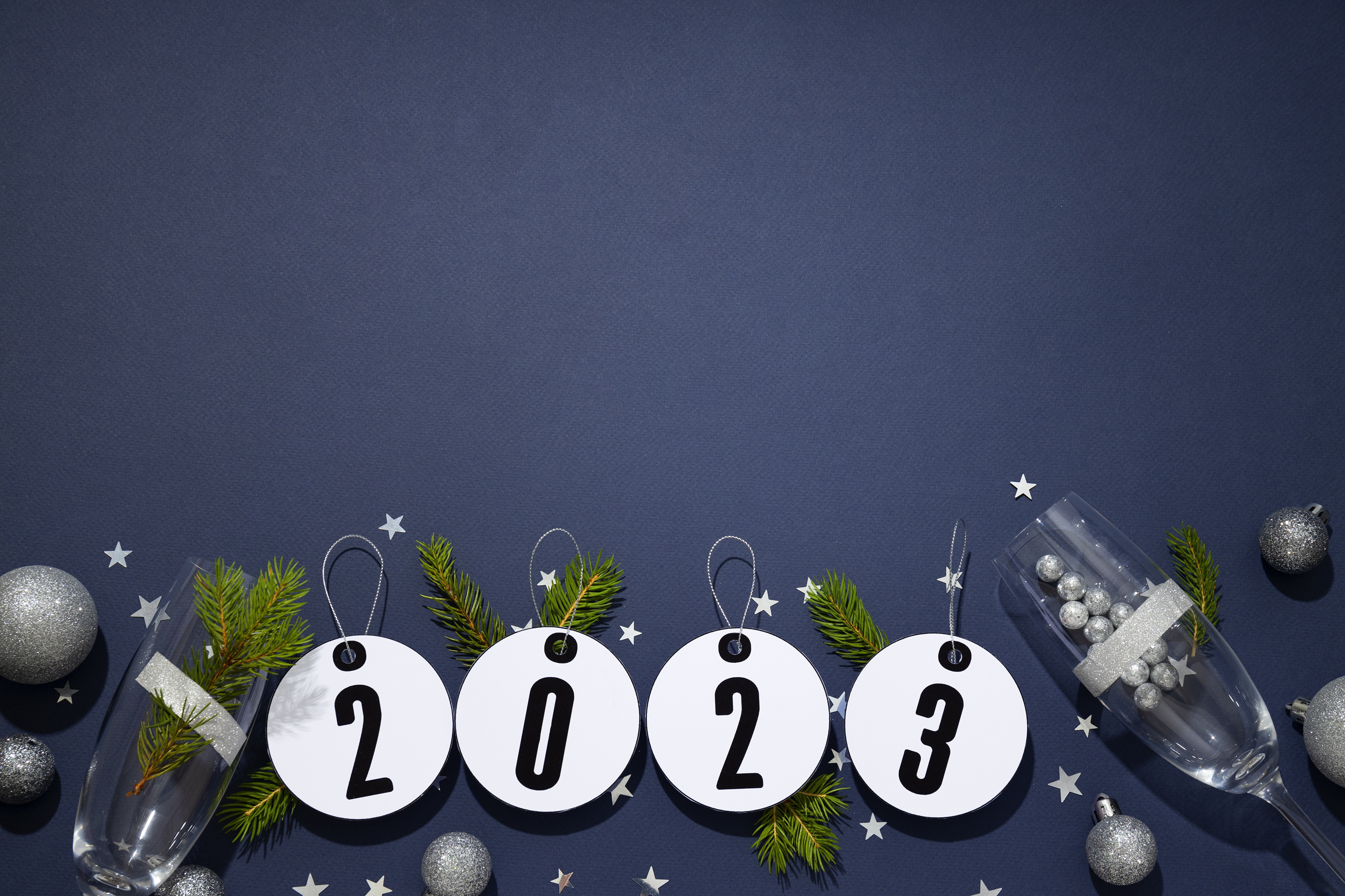 New Year 2023 celebration with champagne glasses and ornaments HD Wallpaper