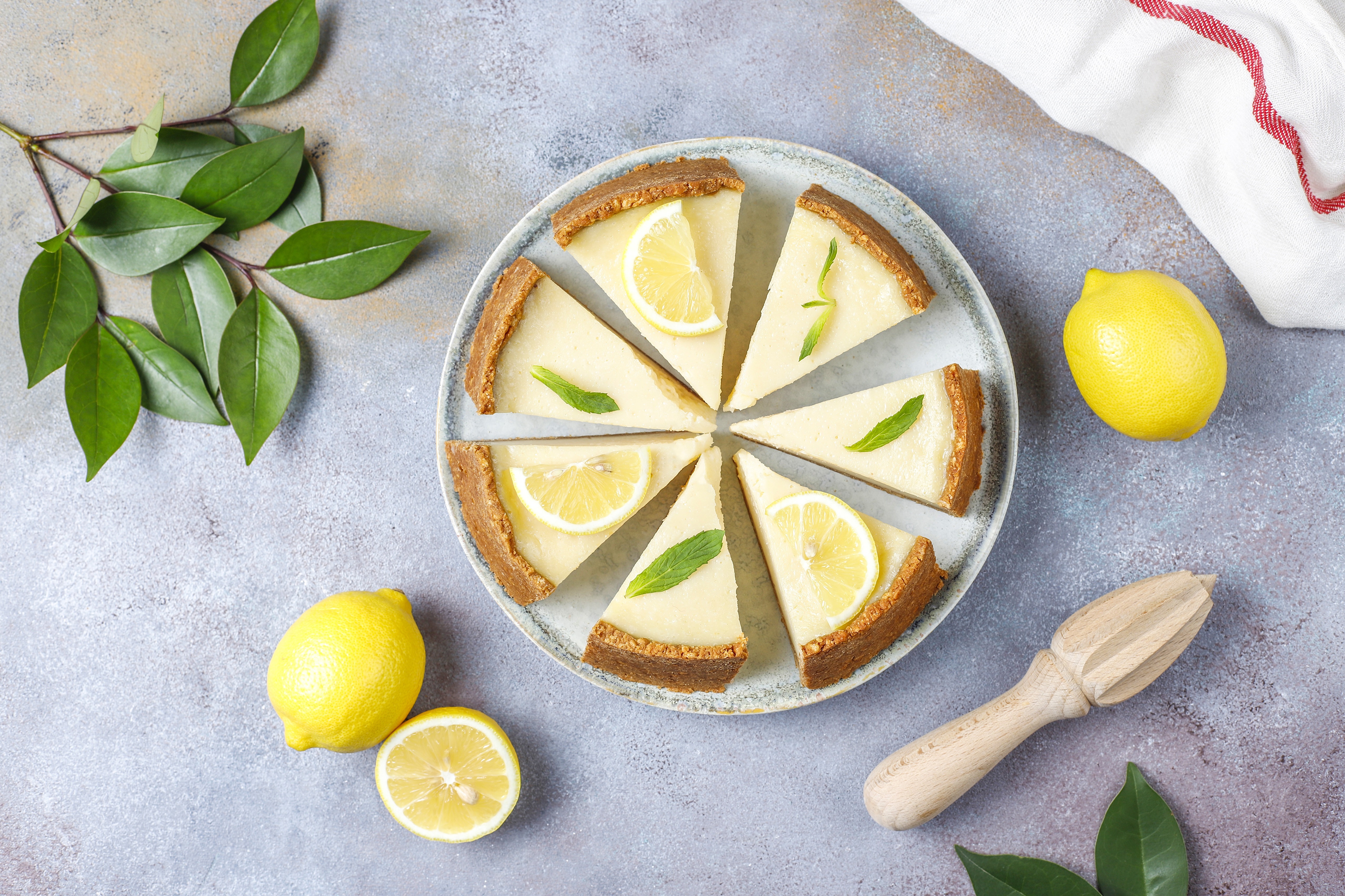 Lemon pie slices on a plate with lemons and foliage HD Wallpaper